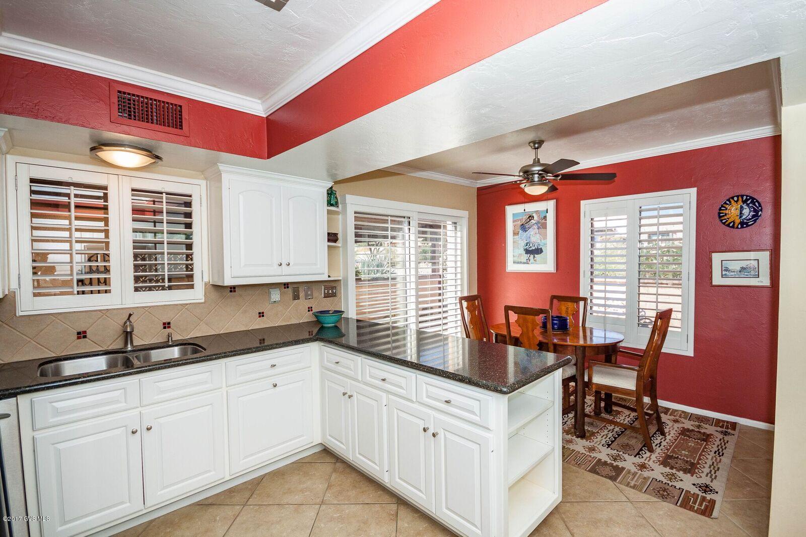 Spacious 1780 sq ft. townhome with mountain views surrounded by natural desert. 2Br/2Ba Elegant kitchen with granite countertops, stainless steel appliances, 18 ceramic tile, plantation shutters. Dining area and living room with decorative gas fireplace, opens to large Arizona room. New Water heater in Oct-17, new skylights/roof re-coat in 2017. Centrally located in Green Valley near shopping, dining and Recreation.