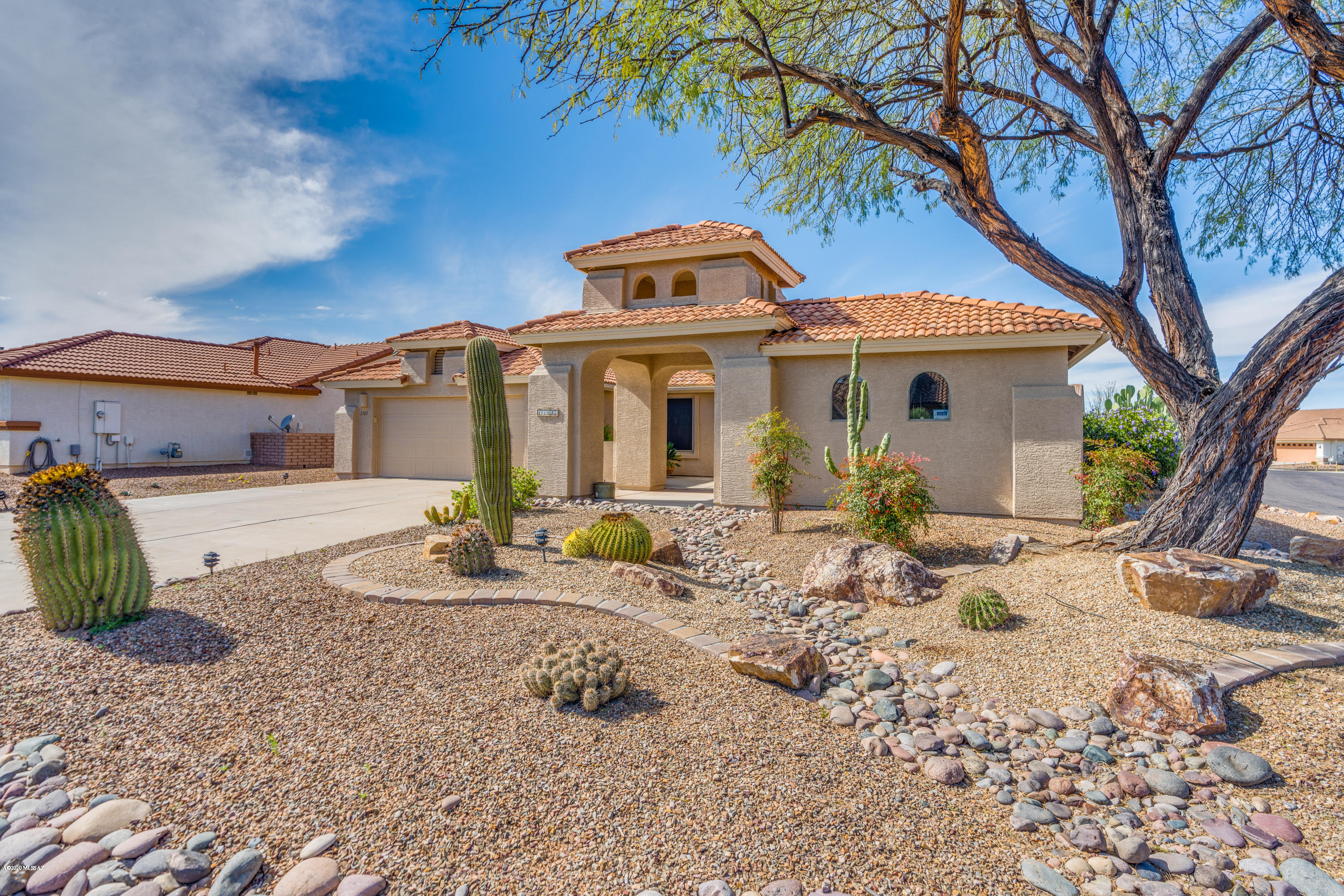The discerning buyer will simply love this Tuscan style home situated on a corner lot with a lovely private back patio. Mature landscaping enhances the amazing curb appeal. Enter a front court yard that offers privacy from the street, lovely foyer with dining room and sitting room with views of the amazing back patio space. Open concept kitchen with solid surface counter tops, stainless steel appliances, convection oven, under counter lighting, and pull-outs in most cabinets. Well appointed den and a split floor plan make entertaining your guests in this two bedroom, two bathroom home a joy. Details include over sized master en-suite with a renovated master bathroom. HUGE walk-in closet and a lovely, quiet master bedroom. Separate guest bedroom and den, private sitting area and a separate dining area. See upgrades list!