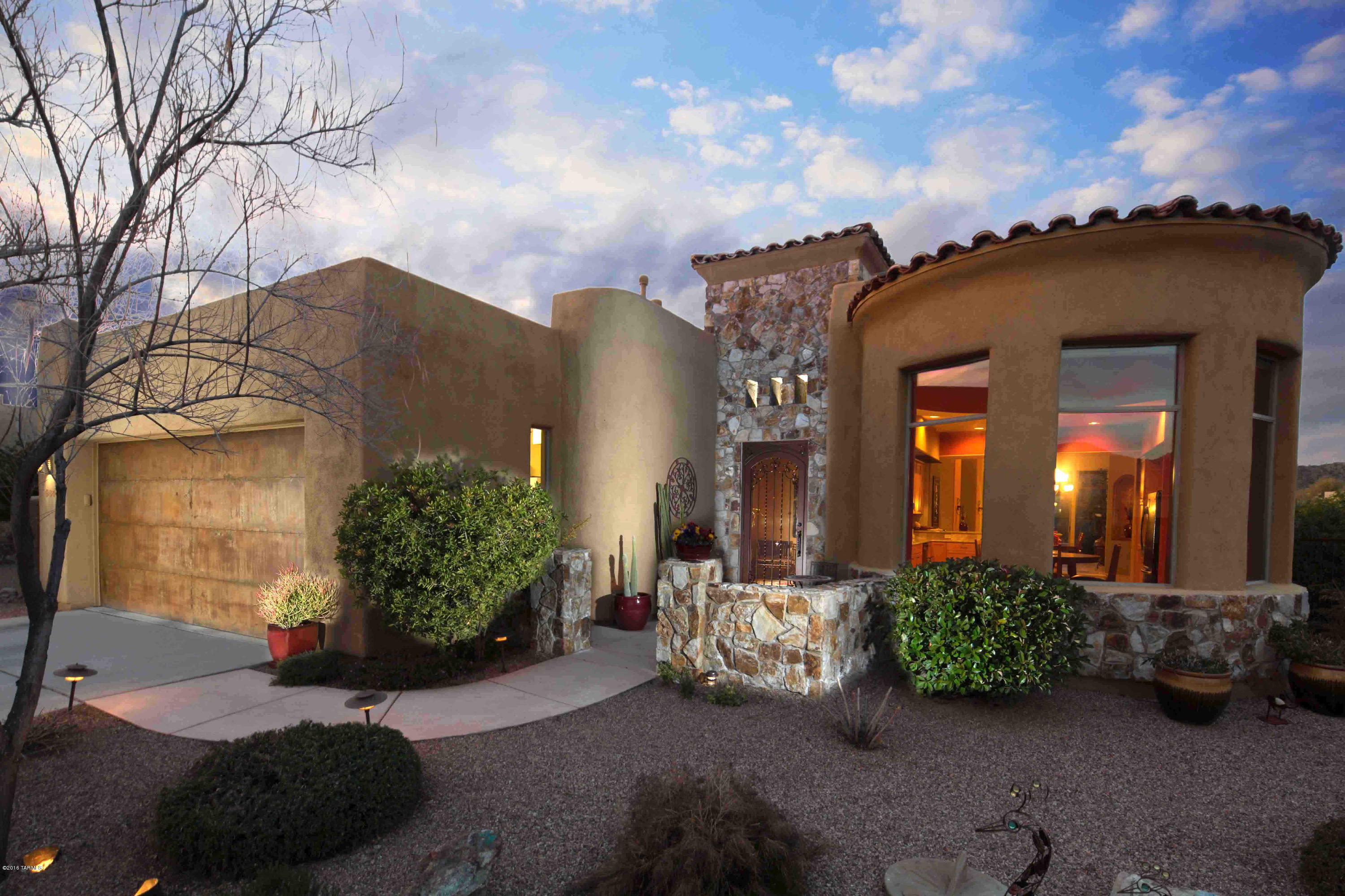 MLS Home Tour Winner! Views, views, views! Stunning views of both the Catalina Mountains and the Tortolitas from all living areas enhance this absolutely gorgeous 3 bedroom + Den home in highly popular Stone Village. This home is on an Ultra Premium Lot at the end of the street and on the 4th hole of the Vistoso Golf Course, but still maintaining privacy. The home features a gourmet kitchen with granite, kitchen island and a breakfast bar. Other features include beautiful travertine tile, custom paint, high end fixtures, and a formal dining area. The living area is large with built-in entertainment center and fireplace. The Master bedroom is resort like with large view windows and luxurious master bath with dual shower heads and a spa tub. The home also has a beautiful outdoorliving area