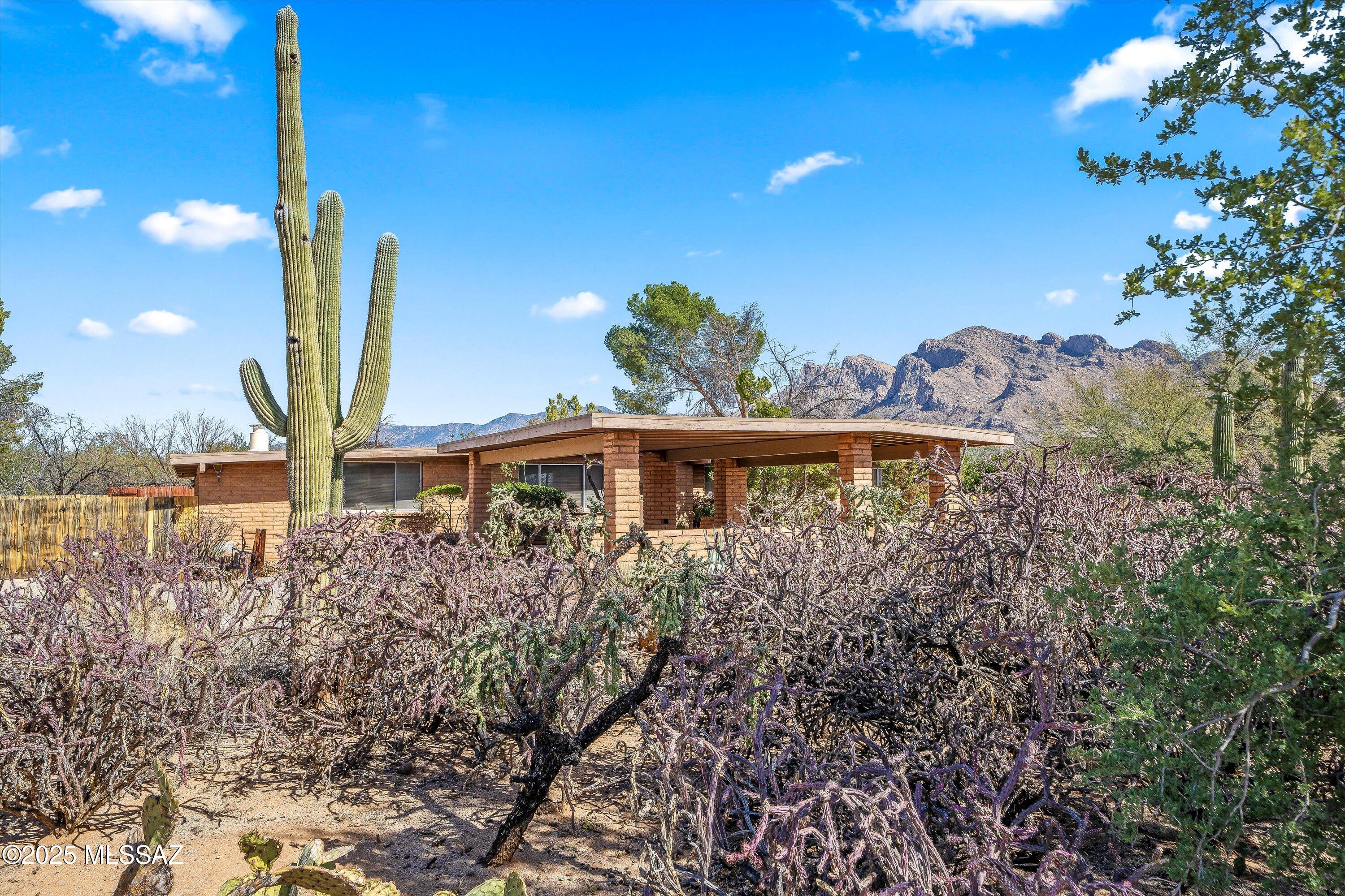 Charming 4BD/2BA (2,654 sq ft) gem located in the heart of Oro Valley. Close to all the amenities Oro Valley has to offer with No HOA on 1.07 acres (horses allowed). Enter to find a separate living, dining area and fabulous great room, with  fireplace and impressive wet bar.  Perfect for entertaining or just quiet night relaxing. HVAC/Wtr Htr new 2023. Roof 2020.   Chef's kitchen host ample counter and cabinetry and lots of natural light. Owner's Suite boasts en-suite bath and large extra area for gym, office or reading spot and private backyard access.Three guest rooms with a full bath. Lovely Arizona Room with built-in cabinetry. Retreat outdoors to several spots, enjoy a float in the pool, sitting under the ramada or playing some basketball all while capturing a mountain view. Must See