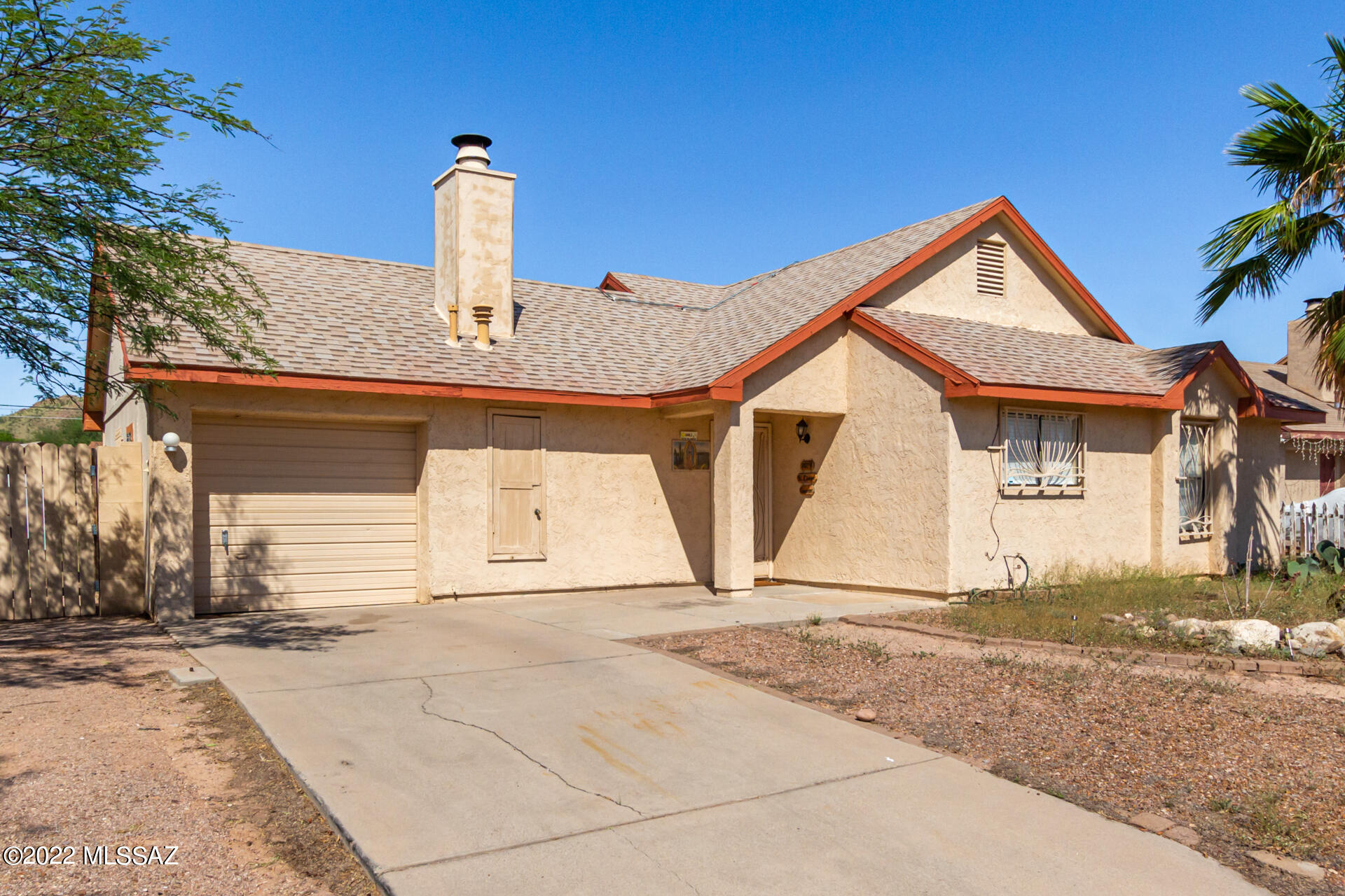 Seller will accept or counter offers between $250,000 - $260,000. Move into this charming ranch-style residence displaying a large front yard, a 1-car garage, & an RV gate! Enter to discover vaulted ceilings, tile flooring, soothing palette, & a spacious open floor plan with sliding glass doors to the back and a cozy fireplace in the living room. The delightful kitchen is equipped with a plethora of beautiful wood cabinets, mosaic tile backsplash, ample counter space, and a 2-tiered breakfast bar. Unwind in the carpeted main bedroom featuring a private bathroom and a walk-in closet. The huge backyard offers a patio, convenient storage shed, a fire pit, parking space for your toys, & incredible mountain views!