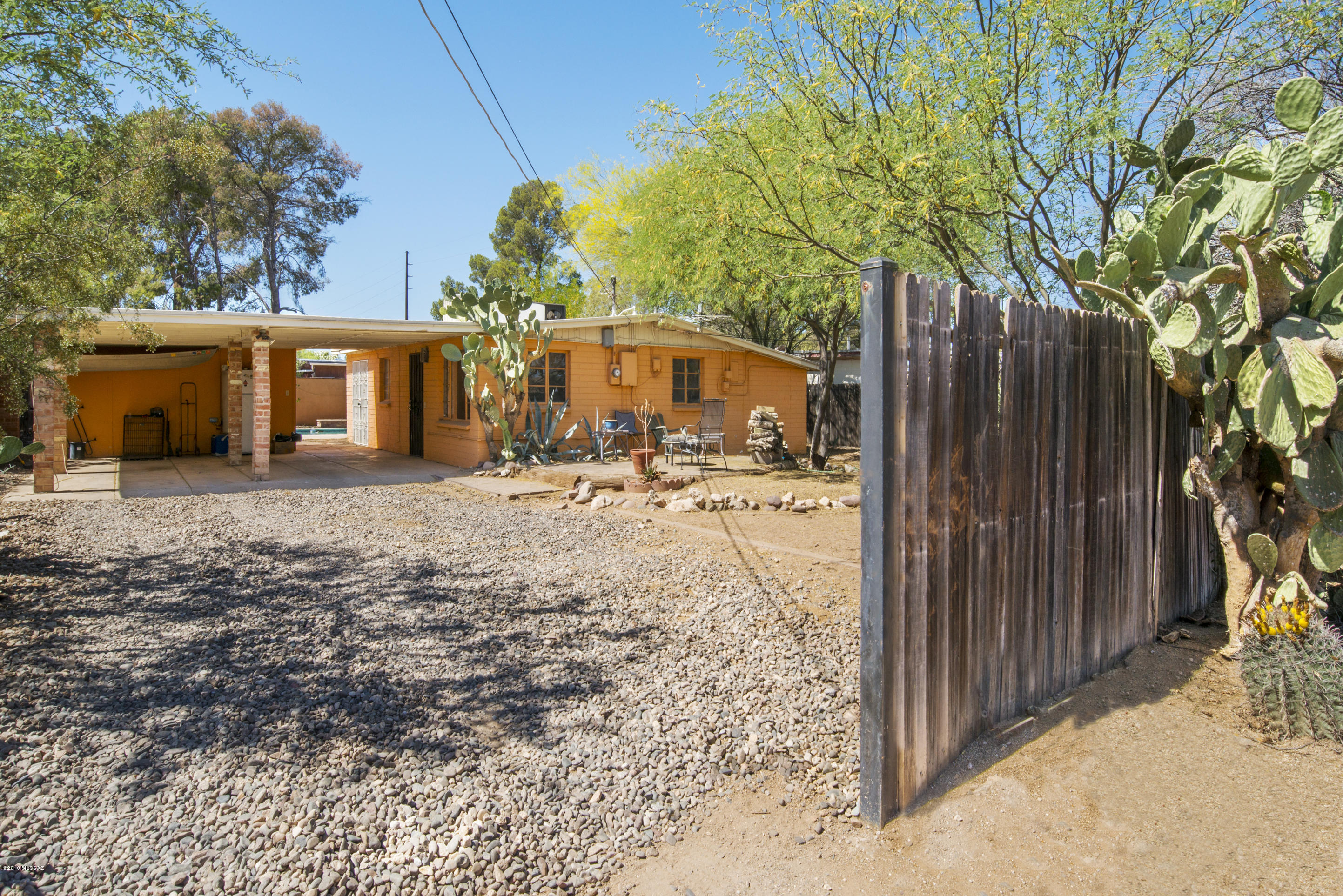 Large lot near Mountain Ave bike path to UofA with 3 bdr one bath concrete block home. A/c & gas heat, mature trees, saltillo tile, separate workshop and storage. Add to that a wonderful sparkling pool