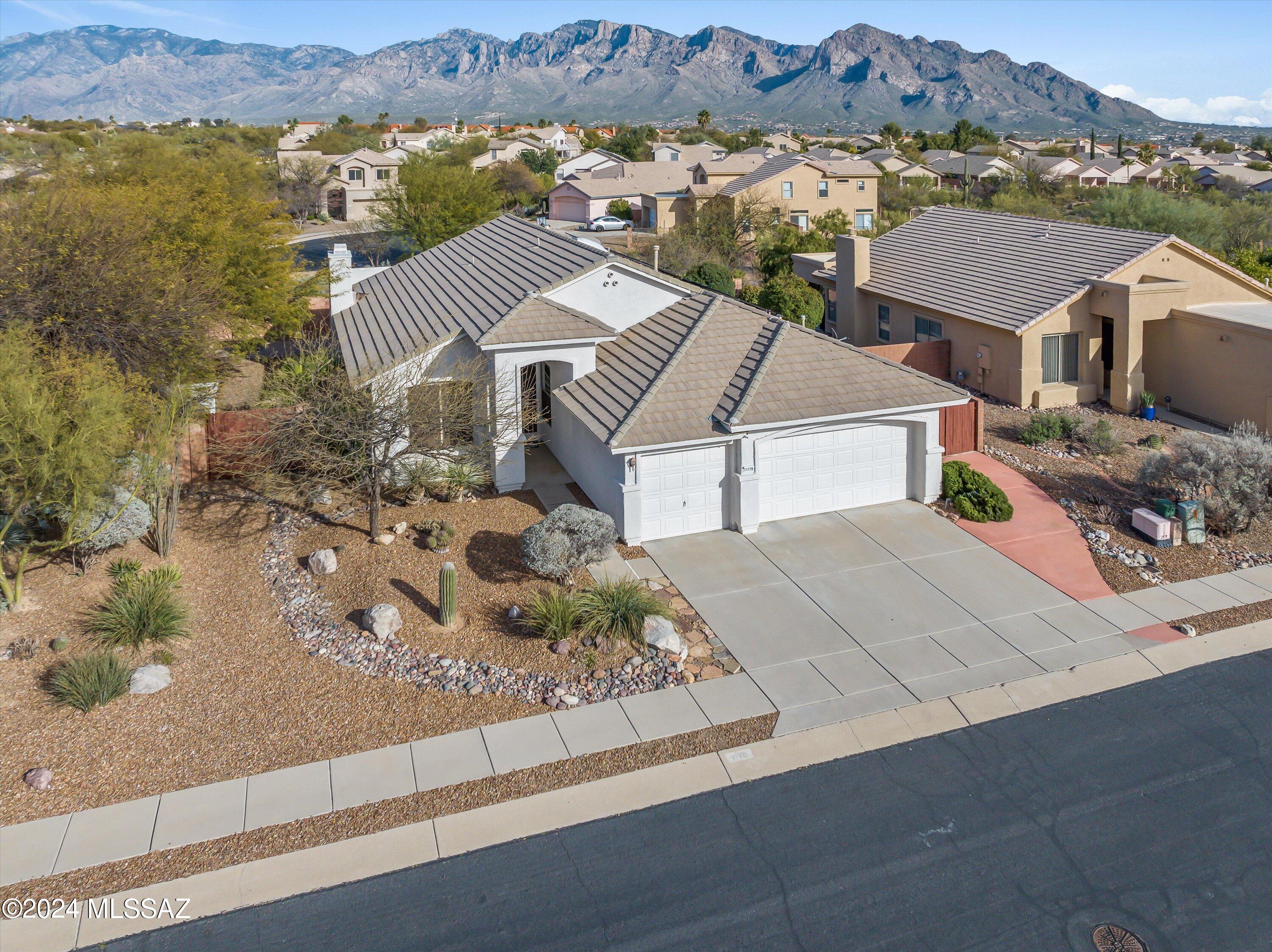Wake up every morning to those magnificent 
Pusch Ridge Views! This beautifully updated home boasts quartz kitchen counters, all wood custom oak cabinets w/ 40'' uppers & soft close drawers, wood-look porcelain tile, interior & exterior painted 2023, pebble tec pool, comfortable back patio and firepit, solar lease, 3-car garage, giant storage shed. No Poly!
