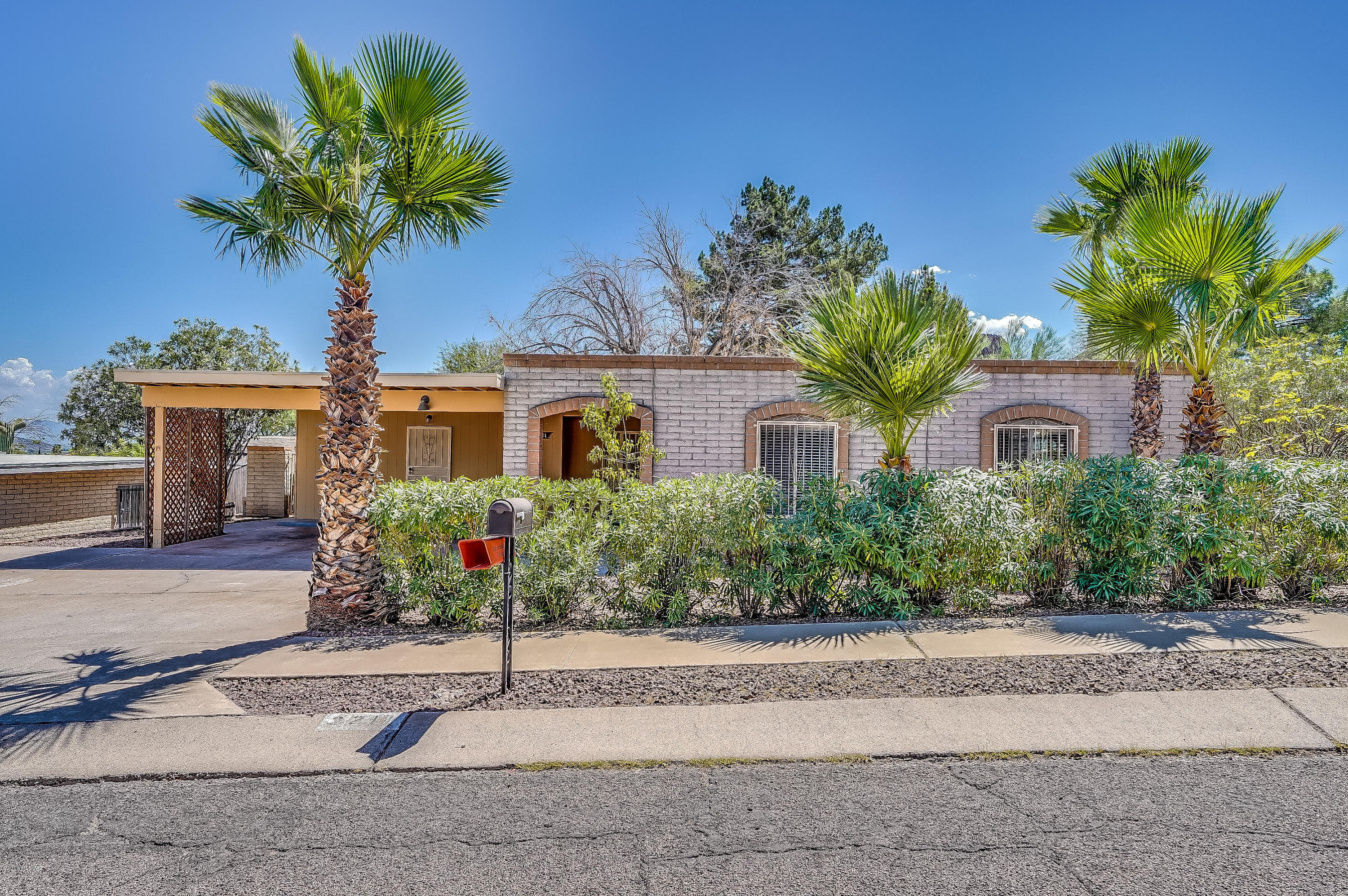 Quiet and sought after Manzanita Terrace with Tucson mountain and city light views! This 3 bedroom 1 & 3/4 bathroom, 1,583 sq. ft. home recently had it's roof recoated in 2018 and fresh new paint on the interior and exterior. Enjoy gatherings in the generously-sized living area enhanced by a gas log fireplace and great glass sliding doors that lead to the large backyard. Backyard features citrus trees, a workshop with storage area (bring your toys!), and plenty of space to sprawl and tinker. Inside the house you'll find laminate wood flooring throughout, a lovely kitchen with breakfast bar area, electric stove oven, stainless steel refrigerator and stainless steel new dishwasher, and new garbage disposal. Easy access to I-10 makes commute time a breeze. Close to downtown, shops, restaurants, bike paths, and the Tucson National Airport. You will love the convenient location of this home!