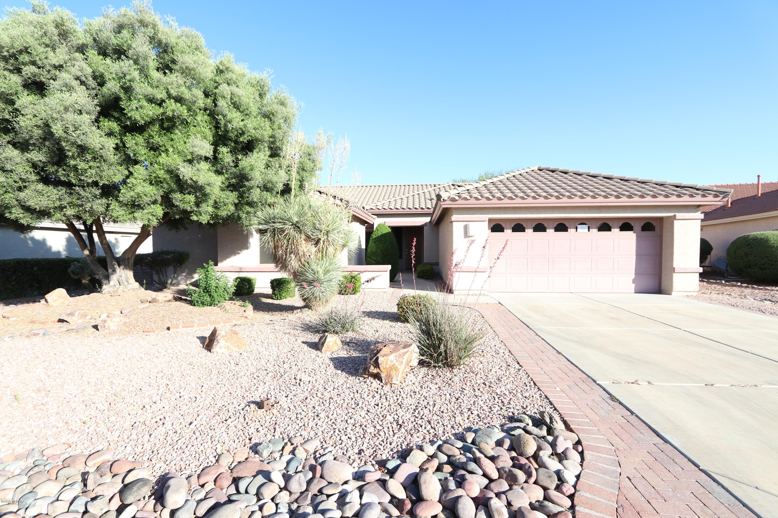 Gorgeous contemporary home in prestigious 55+ Quail Creek community. The main home is a two bedroom two bath.
There is a completely separate mother-in-law Suite with a bathroom, a small kitchenette including sink and small mini fridge. Professional landscaping with pavers.  Huge garage with built in cabinets/storage.  Bonus room could be used as an office or den. Relax and drink your morning coffee in the Arizona room.  Many custom touches throughout this gem.  A must see!