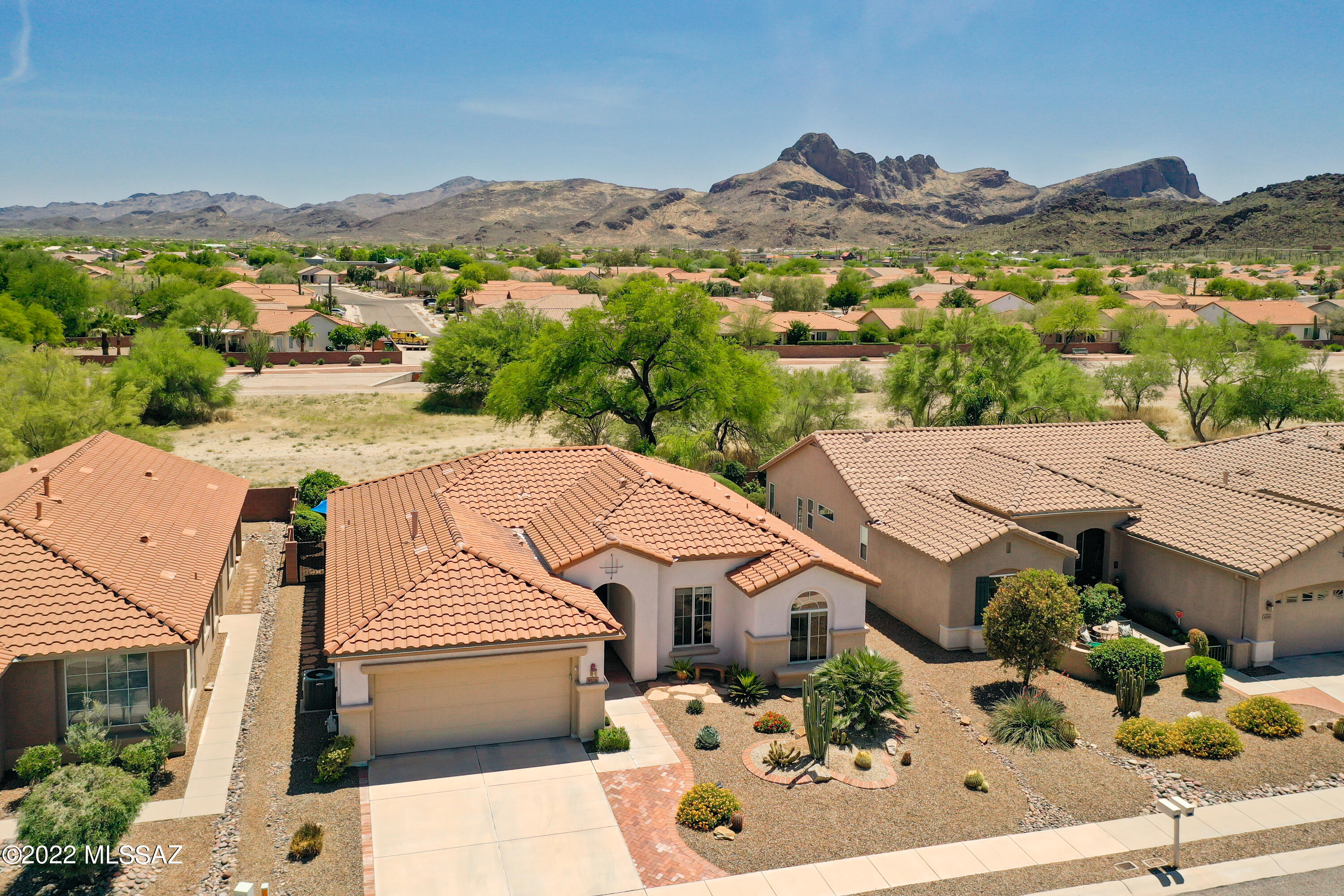 Located in the North Tucson Mountain foothills, the premiere 55+ community of Sunflower is offering this desirable 3 BDRM/2BA San Gabriel model with lots of updates. Redesigned gourmet kitchen hosts Cherry wood cabinets, pantry, Granite counter tops, SS appliances with gas stove. New roof underlayment Oct 2021, water line replaced Feb 2022, HVAC Aug 2015, Water Heater Oct 2019 & Water Tec Softener Nov 2021. Primary Bdrm has bay window & en suite includes updated exec height double sink cabinets, mirrors & lighting. Bdrm #2 has Palladian window. Bdrm #3 & Guest Bath are sure to please. Garage is replete with built-in cabinets. Entertaining paver-extended back patio includes built-in BBQ, knee wall & outstanding views of the mountains.