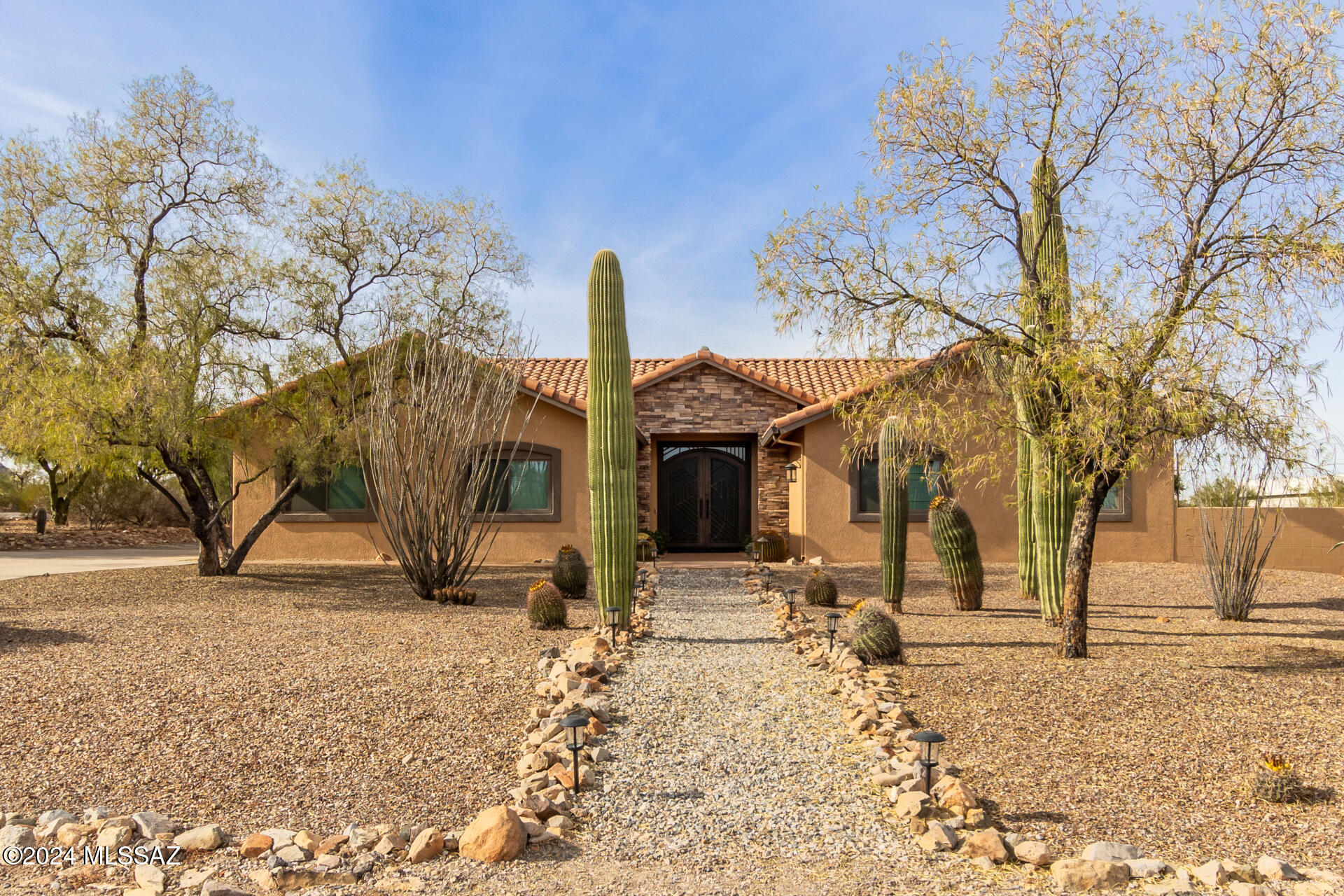 A true Signature Property in the Western Foothills.  This custom home in  the sought after neighborhood of Bridlewood West has everything you've been looking for. This entertainers dream home boasts a resort-like back yard including a huge covered patio, updated pool, firepit and amazing views. The oversized detached 3 car garage has an additional workshop area. 1/3 of the garage is cooled. Not to be outdone, the curb appeal will have you falling in love. The one of a kind custom double doors made of metal and glass prepare for the foyer leading to a grand living room with vaulted ceilings. The Bar, Laundry, and main bathroom all have custom cabinets. Kitchen has a double oven, island, and induction stovetop. Custom walk-in showers, central vac, New ceiling fans, and Newer garage roof. You'll be the talk of all your friends, or you'll make more when they see your home bar with built in cabinetry, sink, refrigerator, lighting, TV and sound system.