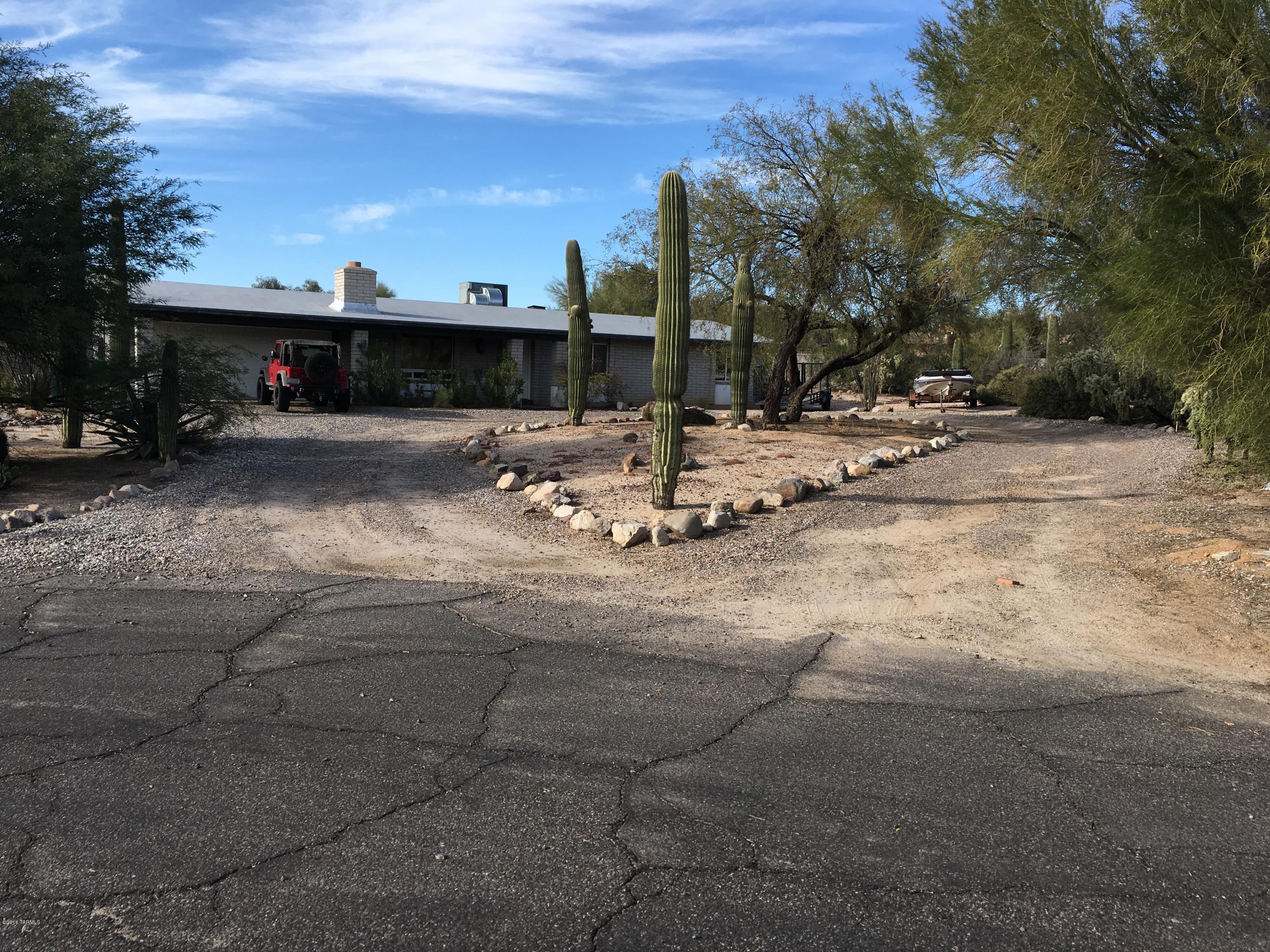 Awesome mountain views from an oversized lot in Oro Valley with no HOA!!! There is an extra large pool in the huge backyard perfect to cool off on those hot Tucson afternoons. 12 inch tile and an updated kitchen with a beehive fireplace are a few amenities you'll find in this home. There are also ceiling fans or connections throughout the home. Large pantry just off the kitchen. The home is located at the end a Cul-De-Sac and promises no through traffic, no street noise, and added peace of mind. Double gates for RV parking are also an added benefit.