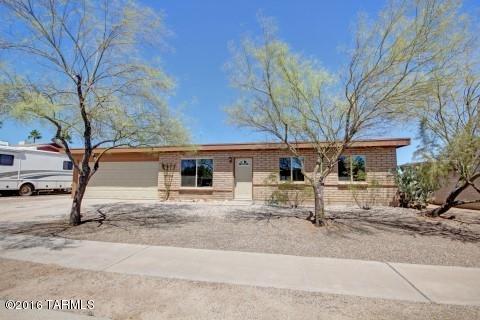 'Neat As a Pin' and Move-In Ready! ALL NEW (April/May 2016): A/C, windows, glass slider, interior paint, carpet, microwave, disposal, front door, outside light fixtures plus all popcorn removed. 1054 sq ft masonry 3 bed/2 full bath home includes new roof (2014), updated kitchen with newer appliances, S/S double sink, pantry & tiled breakfast bar, remodeled hall bath & newer vanity in master bath. Large backyard with covered patio, citrus trees & mtn views. 2 car garage with space for workshop. All appliances included plus washer/dryer. Desirable NW neighborhood close to restaurants, shopping, schools. Don't miss this little gem!