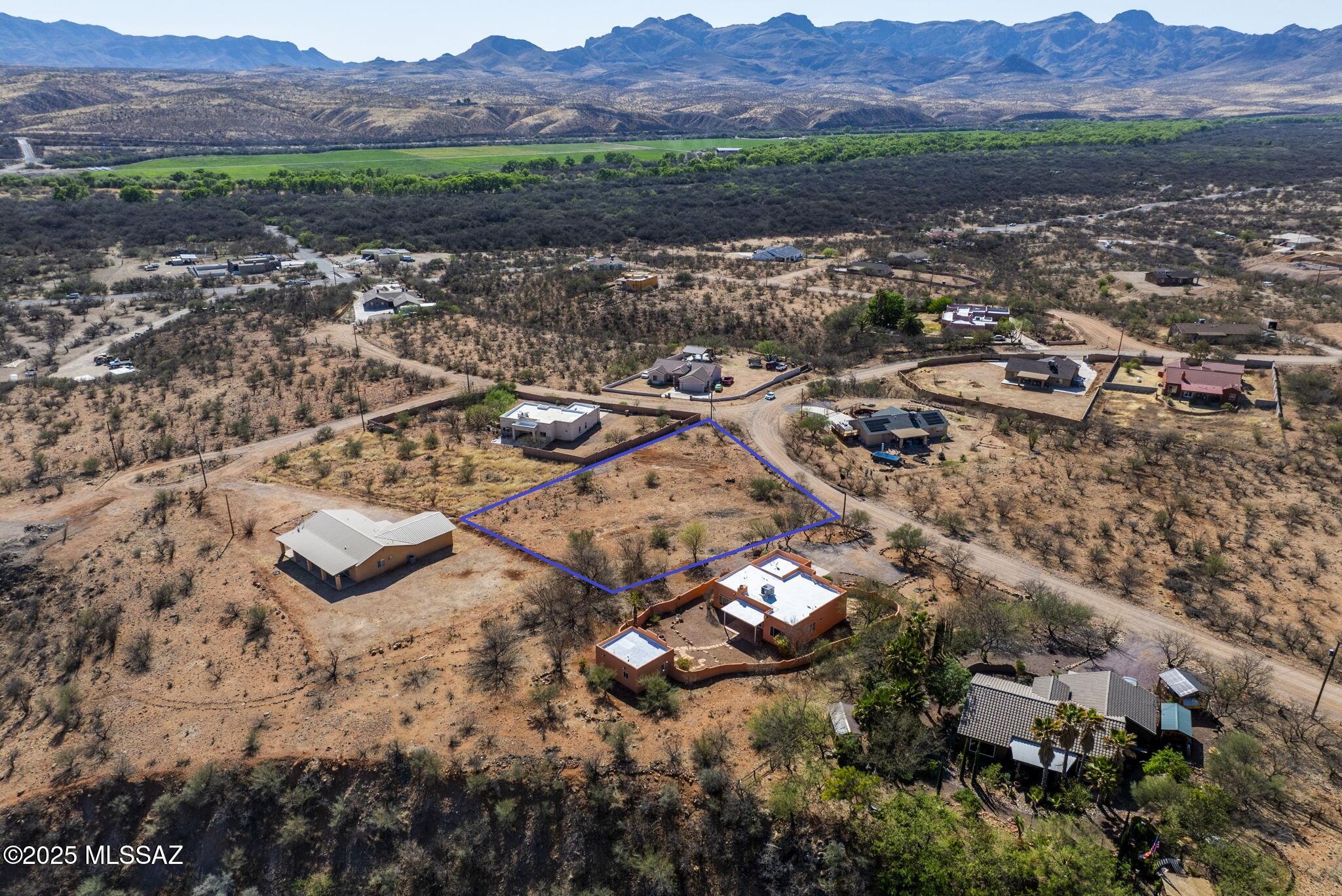 Nestled on a premier 0.59-acre lot in the peaceful Rio Rico Ranchettes community, this exceptional property offers an ideal setting for a custom home/development opportunity. Zoned for residential use with mostly level terrain, it requires minimal excavation. A recent percolation test was successfully completed, and utility connections are available along the lot lines for easy development. Enjoy sweeping mountain views and the picturesque Santa Cruz Valley, all just minutes from I-19 via the Palo Parado Road exit - offering both convenience and tranquility. Do not miss your chance to own in one of Southern Arizona's most desirable areas!