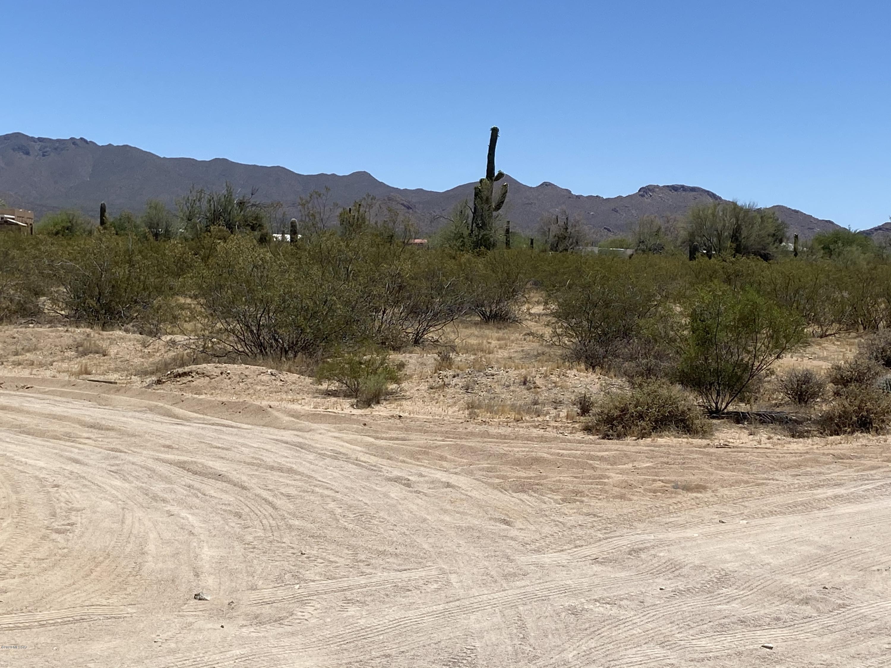 Nice buildable lot with mountain views at the end of pavement.  All utilities very close. Avra Valley water co.  Mature Saguaros, lots of desert vegetation.  Great spot out of the way yet close to I-10, shopping etc.  Picture Rocks has a wonderful community center offering a wide variety of activities.  Great piece of land to build your custom home or place a manufactured home on.  With almost 5 acres you can be snuggled in your own little sanctuary with all of your animals or toys close by.
