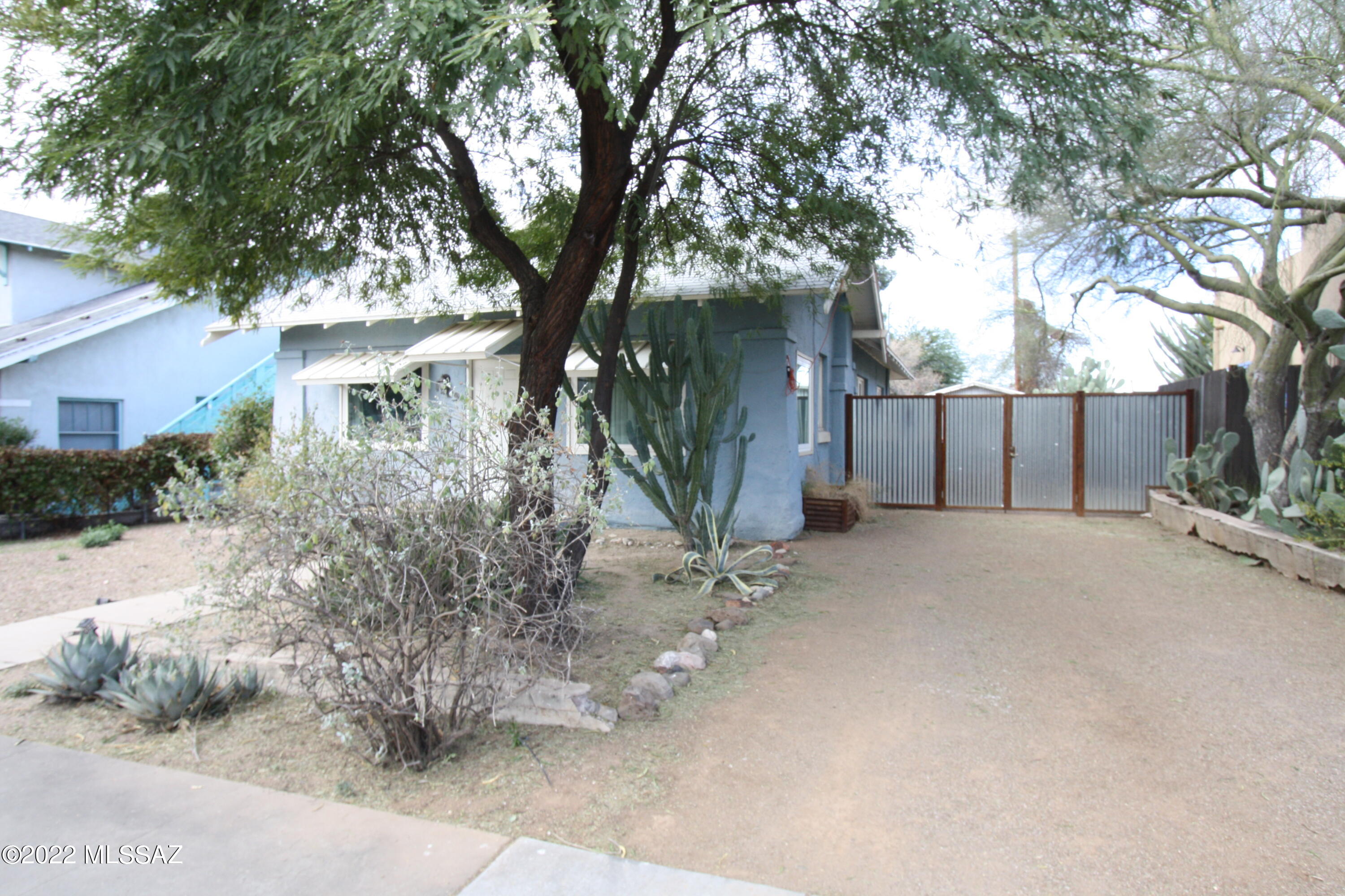 Great find in the HEART of Tucson - Updated bungalow in historic Feldmans neighborhood!  Reflects early 1920's Charm with a modern touch! Front offers entry mudroom/office space with windows,  welcoming you home with natural light. Newer hardwood floors take you through the home to front living room, dining area and 3 spacious bedrooms. Solar panels to help reduce electric bill. Upgraded windows, and recently remodeled kitchen. Washer and dryer included just off the kitchen. Large backyard with citrus trees and gazebo to enjoy time outside when home. Plus, bonus storage unit in backyard! Property is tucked away, but just blocks from downtown, UofA, restaurants, and more! Call today!