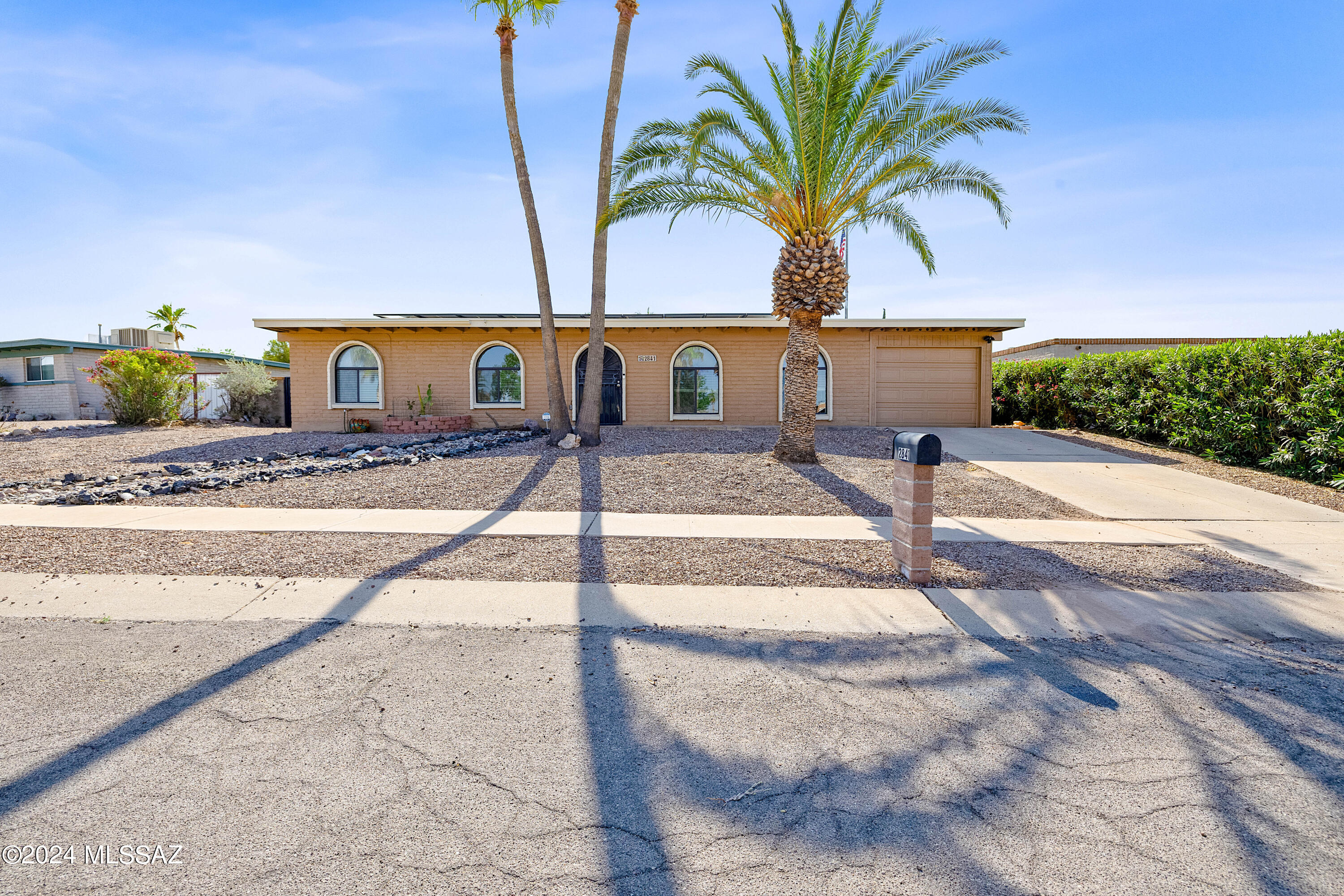 This beautifully updated three-bedroom/two-bathroom home is located on an oversized lot in East Tucson! The immaculate interior boasts an open concept floor plan with a spacious dining area, kitchen and living room. The interior features include: fresh paint, an abundance of cabinet space, granite countertops, premium stainless steel appliances with an oven that doubles as an air fryer, recessed lighting, master walk in closet, tiled in showers, upgraded bathroom vanities with medicine and wall cabinets, ceiling fans, two hall closets, ceramic tile throughout with colored concrete in the laundry room, a 1 car garage, and tons of natural light! Outside, enjoy an entertainer's delight with a sparkling pool, an elongated covered patio, no direct rear neighbors and a block wall for privacy all around and fresh exterior paint! With NO HOA, but ample parking space, bring your toys or trailers! Buyer to assume solar loan, enjoy low energy bills with assumable low interest rate of 1.99%!