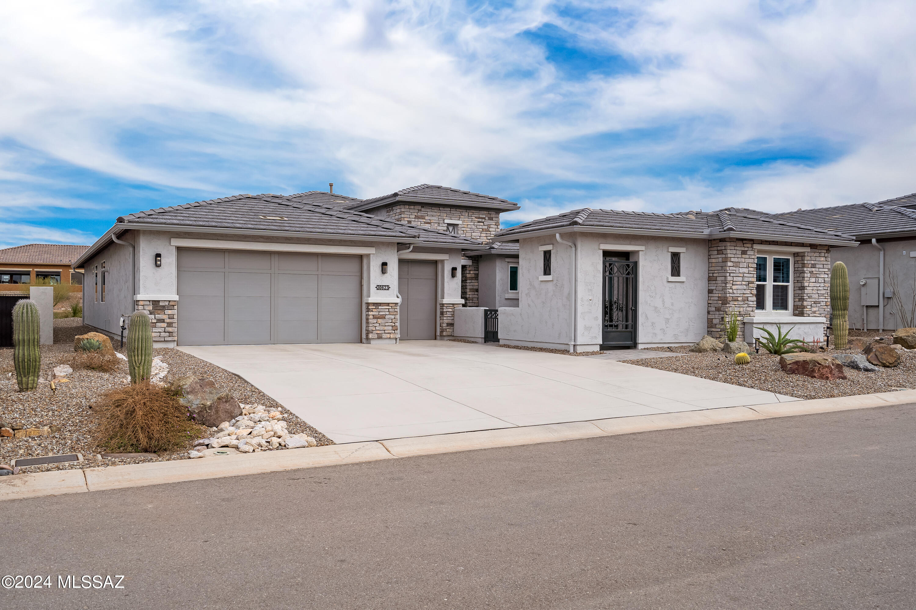 Welcome to the highly sought-after community of SaddleBrooke Ranch, where this stunning & rarely available, highly upgraded, Tesoro with a Casita awaits.  Enjoy the harmonious blend of contemporary design and timeless elegance. This home is a sanctuary for anyone seeking both comfort and relaxation. Enter through the elegant foyer to the Great Room which features a beverage center with two wine refrigerators. The stunning kitchen features Black Stainless-Steel appliances, designer backsplash, white shaker style upper cabinets and gray lower cabinets; all featuring soft close doors and drawers.  The cascade Quartz-topped Island is the centerpiece of this chef's dream. The primary suite has many extras that promote its spa-like appeal. In addition to the soothing soaking tub, the suite also contains, dual vanities, two walk-in closets with built in custom cabinetry, and a spacious shower.  The split bedroom floor plan offers you and your guests additional privacy, and the den can serve as an office or additional TV room. The Casita is an amazing space for guests, an office, craft, or game room. The home also offers two-tone paint, upgraded wide plank neutral tone wood looking tile flooring, and plantation shutters. Walk out to your amazing extended paver patio with Rolling Shades and enjoy the outdoor living that is the signature of Southern Arizona. The garage is oversized and has opulent epoxy floors, tankless water heater and whole home water filtration system. This home is in like-new condition and has many more features than mentioned, it is not to be missed!  Why wait to build when you can start enjoying all that SaddleBrooke Ranch has to offer today.