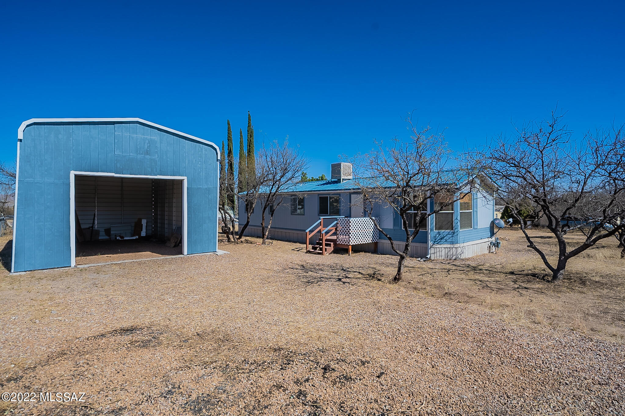 Clean and updated 2 bed/1 bath manufactured home. 18x30 metal building to store RV or toys in quiet neighborhood. Laminate wood floors, decks in front and back, storage shed, metal roof. Refrigerator, stove, evaporative cooler and water heater all replaced within last 5 years. Home is being sold furnished. Adjoining lot is included in purchase. Tax parcel #124-15-438. Sold AS-IS
