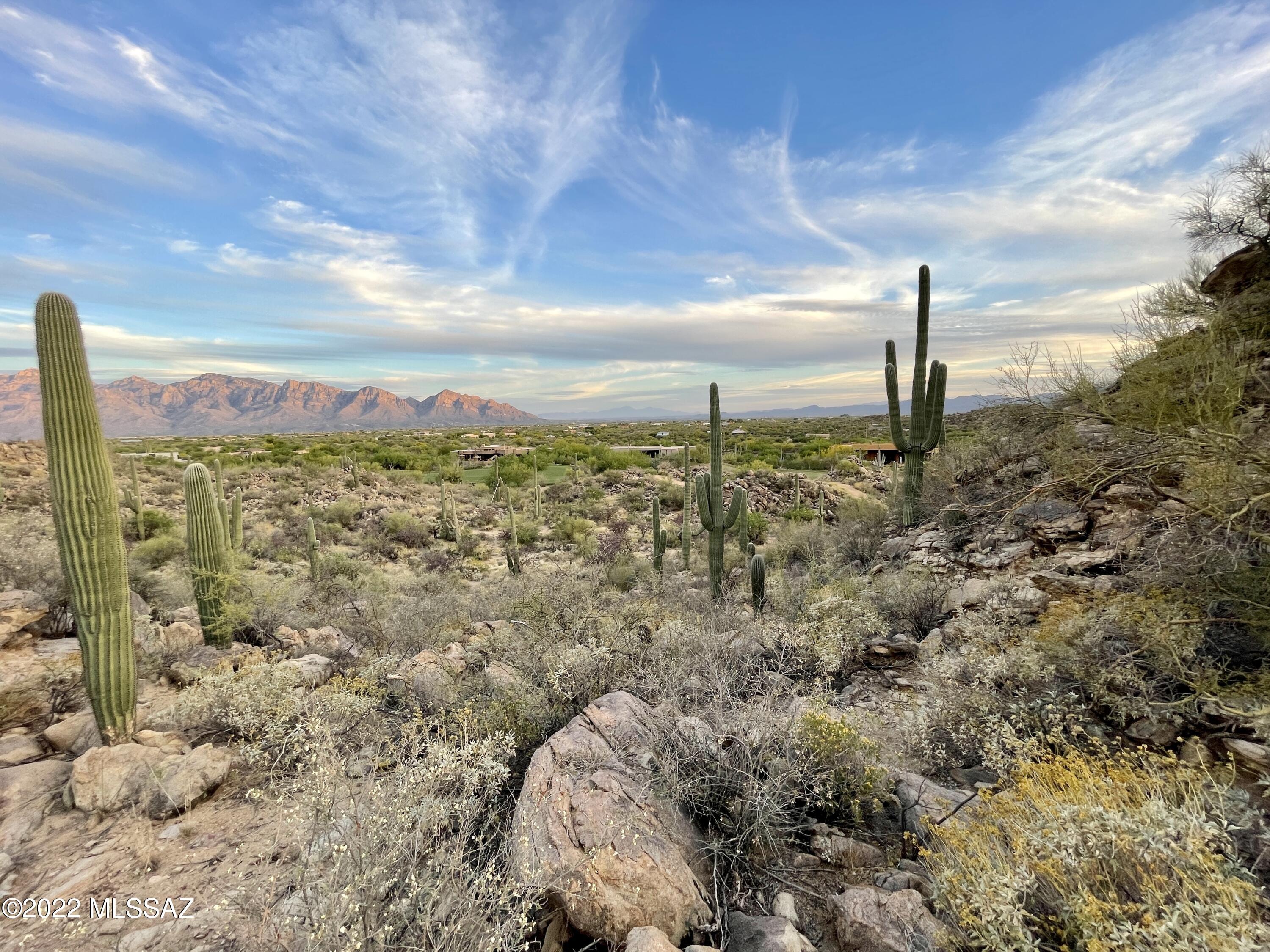 Everyone wants that elevated parcel giving you that ''on top of the world view''. Now on the market and ready for you to build your dream home.  Looking thru 2 corridors you will find incredible mountain and city views... from the other Southwesterly views of Tucson Mountains and sunsets. Enjoy Stone Canyon Golf Club amenities include world class Golf, Fitness Center (Tennis, Pickelball and Lap pool) Minimum requirement of Sports and Social Membership. Ask for details.