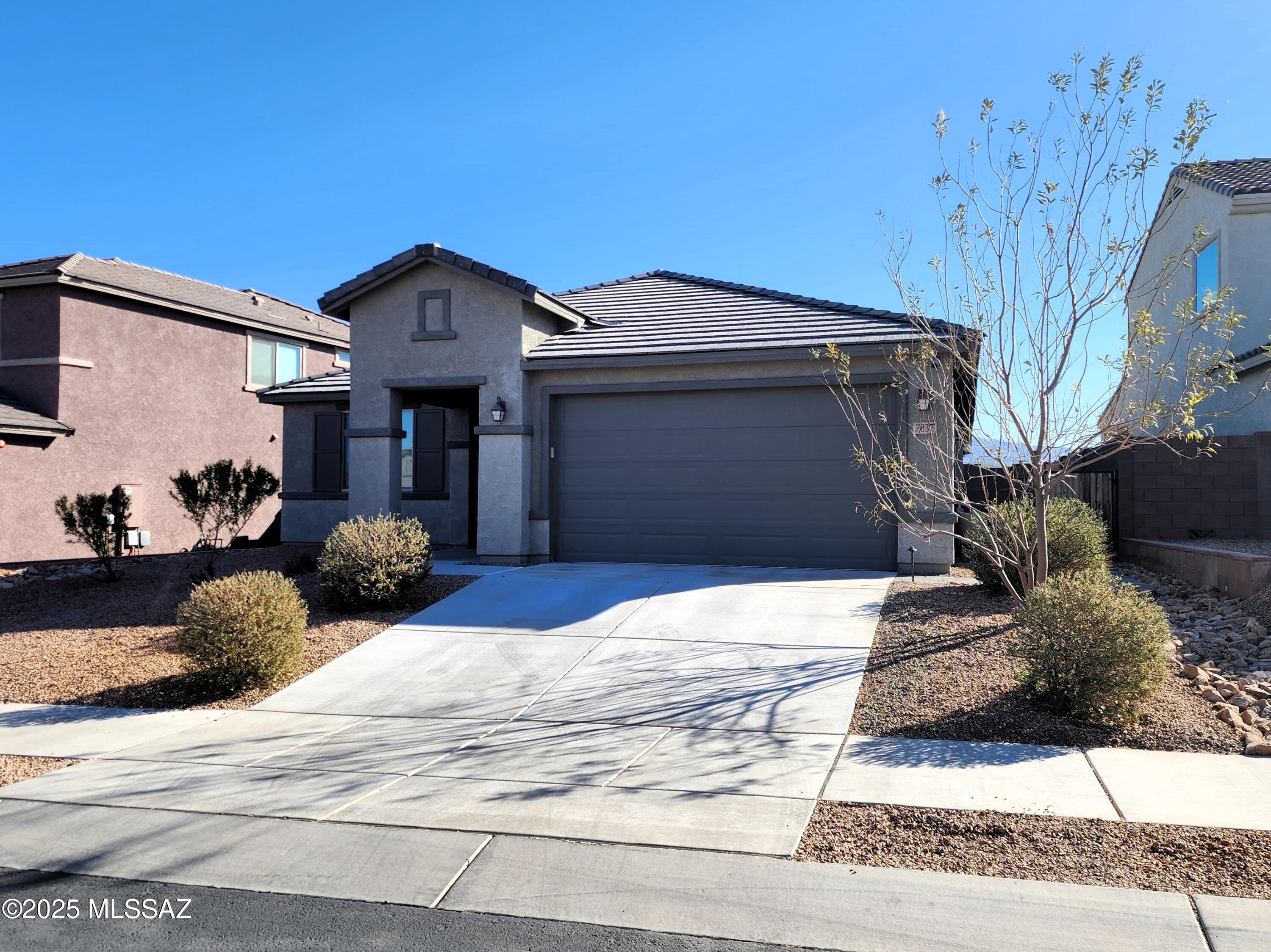 This property sits on a peaceful and private lot with no rear neighbors featuring a 2.5-stall insulated garage with AC, equipped with a 240-volt circuit, along with extra lighting and power sockets. The lighted exterior's landscaping with paved paths eliminate dragging refuse bins through the mud. Enjoy outdoor living with an extended patio and a natural gas hookup. The low-maintenance front and backyards have drip irrigation. The seller is enrolled in the optional TEP GoSolar Energy Fixed Rate Energy Plan. The home also incorporates a radiant barrier in the attic to further enhance energy efficiency. Stay connected with a built-in business-grade networking package offering multiple access points and CAT6 ethernet wired to all major rooms. There is also a pre-installed security system.