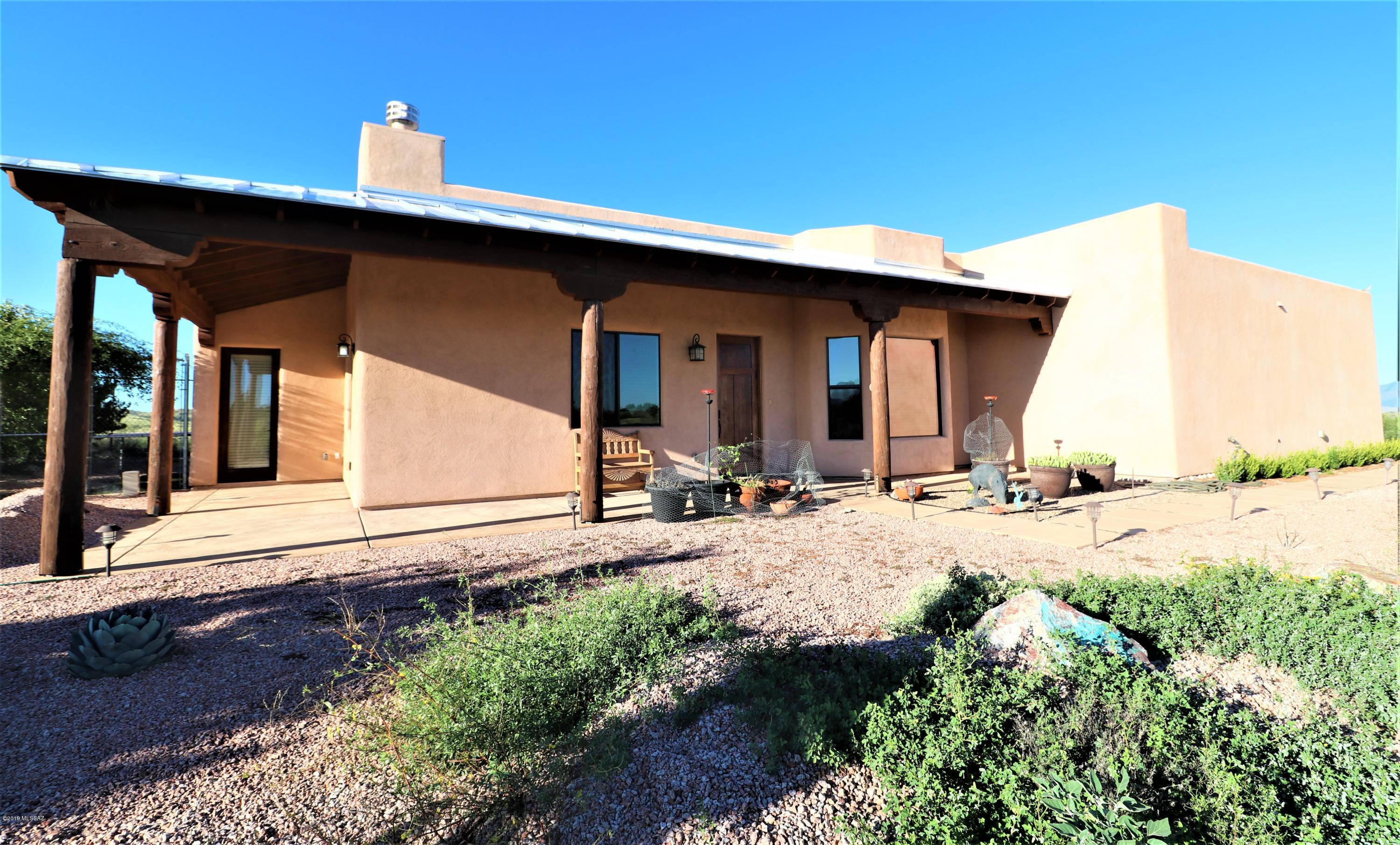 A spellbinding property north of Sonoita where majestic tranquil scenery is matched equally w/an energy efficient home carefully constructed of thought & detail sited on hilltop to optimize Incredible unobstructed 360 Mtn views! A fully paid for 4.9 KW Solar Photovolatic system in place w/TEP power co. net metering. If you like to garden & harvest fruit, then be amazed by the 8' high fenced-in small orchard alongside the home set in decorative gravel/pavers w/water harvest irrigation drip system, private well & treks decking on elevated Ramada. Home boasts high ceilings, knotty alder wood doors, quartz counter tops, gas FP, radiant floor heating, beamed ceiling, skylights, water softener, in-ground propane tank, over sized 2 car garage w/post tension entry slab. A great Value in Quality!!