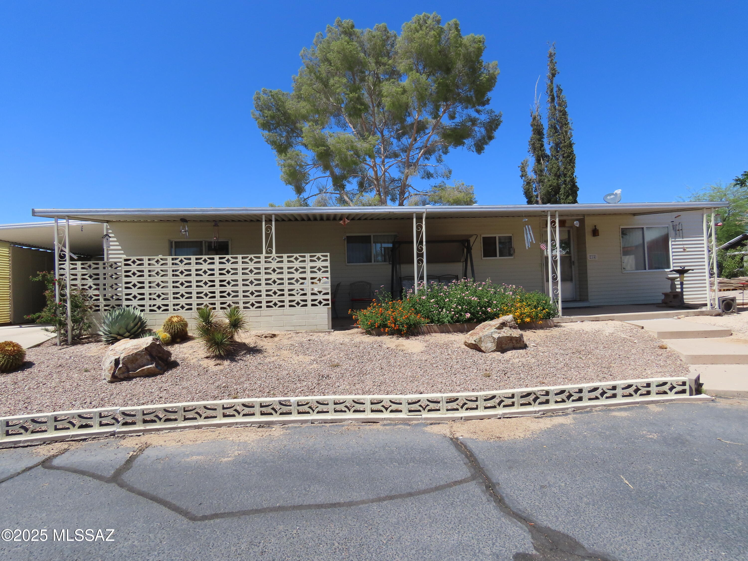 Nestled in the heart of  Oro Valley.  This is in a highly sought-after 55+ active adult mobile home park community in Oro Valley with fabulous  mountain views. Resort style retirement community. The community has a pool and a club house plus many activities.  Land is owned. This home offers 2 bedrooms and 2 bathrooms, stunning mountain views in the large living room. This is an extra-large lot, with a clear view of the Catalina Mountains.  Enjoy the covered patio with a stunning mountain view.  Ground set no steps. Fully furnished too.  Perfect home for seasonal  or full-time residence. The location is extremely convenient, and close to everything. Rentals are allowed. Service animals only. Consult CC and R's. Possibly emotional support animals are allowed but will need to be verified.