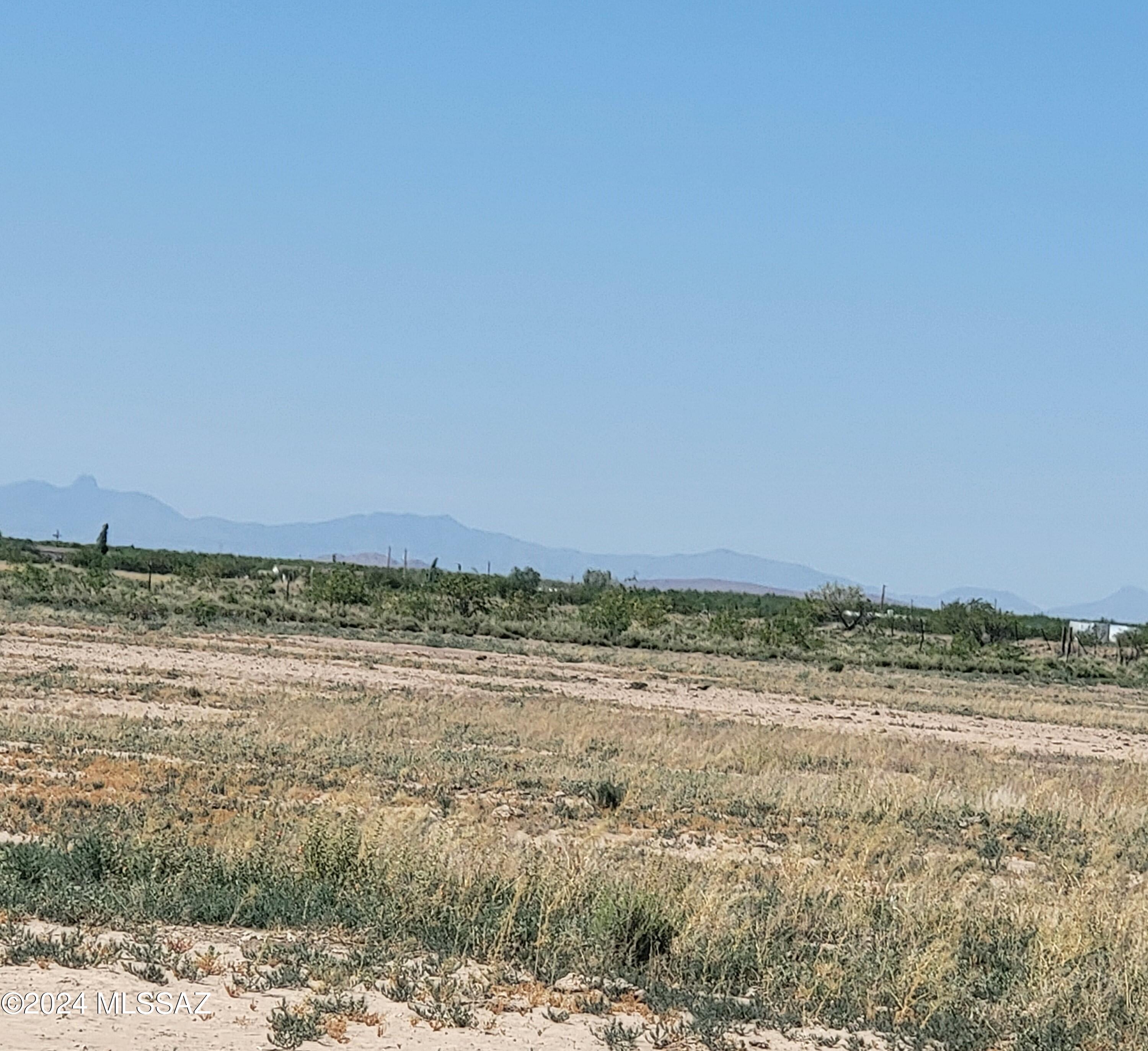 Nice flat piece of property .  Water and septic already  installed on the property.   Totally fenced and on PAVED Street. Ready to go to build your Rancho in Cochise County.  Great views of all the surrounding Mountains.  MFH allowed.