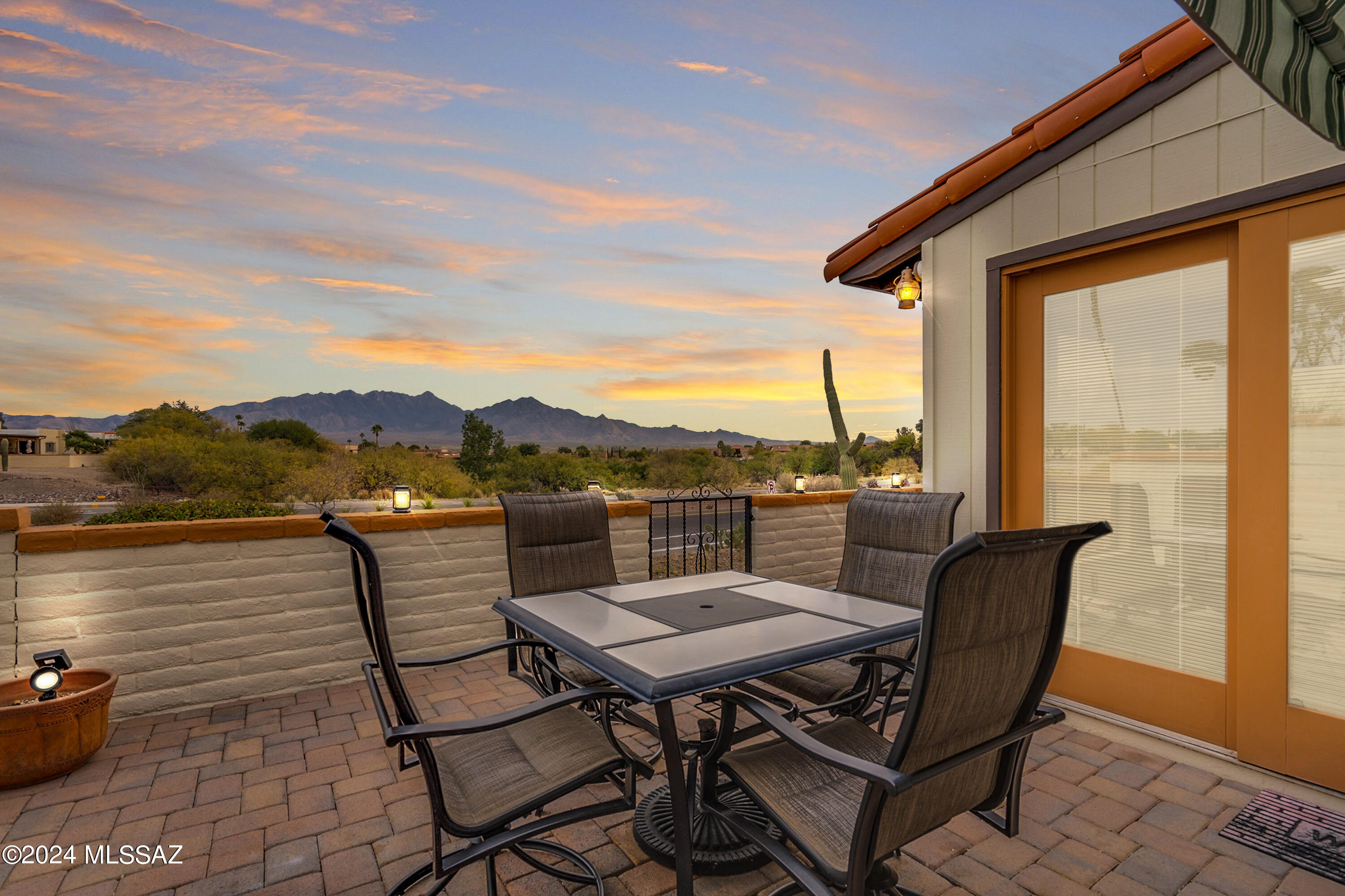 FURNISHED, turn-key end unit townhome with MAGNIFICENT VIEWS in Desert Hills 3 West. Updated interior offers 2 BR, 2 BA with plank style ceramic flooring throughout, dual pane windows, contemporary finishes, newer bath vanities, updated window treatments, 3 ceiling fans, five skylights and no popcorn ceilings! The spectacular Arizona Room is where you'll spend countless hours enjoying sweeping views of Mounts Wrightson, Hopkins and Elephant Head. Expanded laundry area with storage pantry. Additional storage rooms off carport and the AZ room. Two new HVAC units (2023), one for the main living areas, and another for the AZ room. Ideal as a full or part-time residence, or investment property.