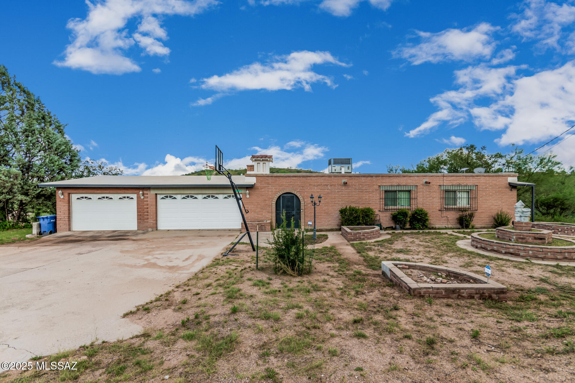 Look no further! This single-level charmer with a 3-car garage is the perfect one for you! Inside, you'll find a welcoming living room with easy-care tile floors, plus a family room with exposed beams, wood-look floors, and a crackling wood-burning fireplace. The kitchen is a true crowd-pleaser with stainless steel appliances, granite counters, a stylish backsplash, and cabinets galore. The primary suite spoils you with a walk-in closet, private bathroom, and direct access to the relaxing AZ room. Out back, a covered patio and oversized yard are just waiting for cookouts, games, or your dream outdoor oasis. Spacious front yard perfect for a landscaping view or creating a welcoming entrance to your home. What are you waiting for? Start enjoying lasting memories in this beautiful home!