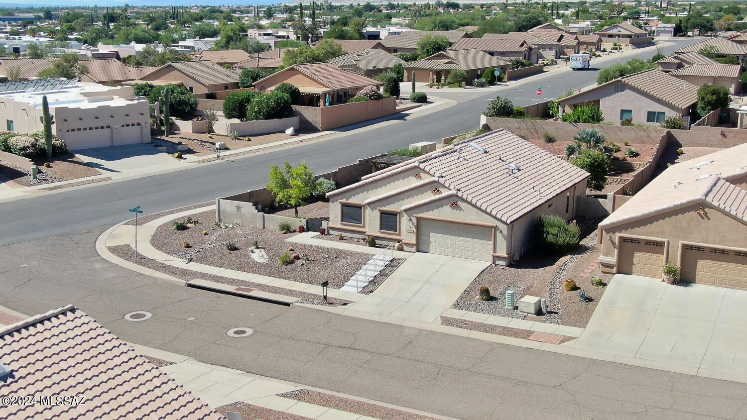 HUGE PRICE REDUCTION  Corner Lot 2BR, 2BA & Den.  Original owner has taken pride in this home as you will see. As you enter you will walk into a Large great room with gas fireplace & high ceilings.  Nice large kitchen with pullouts, large island & pantry. Most appliances are less than 2yrs old. Split floorplan is great for guests. Guest Bedroom has a nice walk-in closet, Den has built ins for office space.  All windows have sunscreens. Beautifully maintained yard covered patio for entertaining. Beautiful mountain view from the front. Nice size primary suite with door to go to the backyard, large walk-in closet. Oversized garage features a work bench and cabinet that convey. Great home & backyard for entertaining. Shopping/Dr's all nearby. Exterior recently painted, & roof maintained.