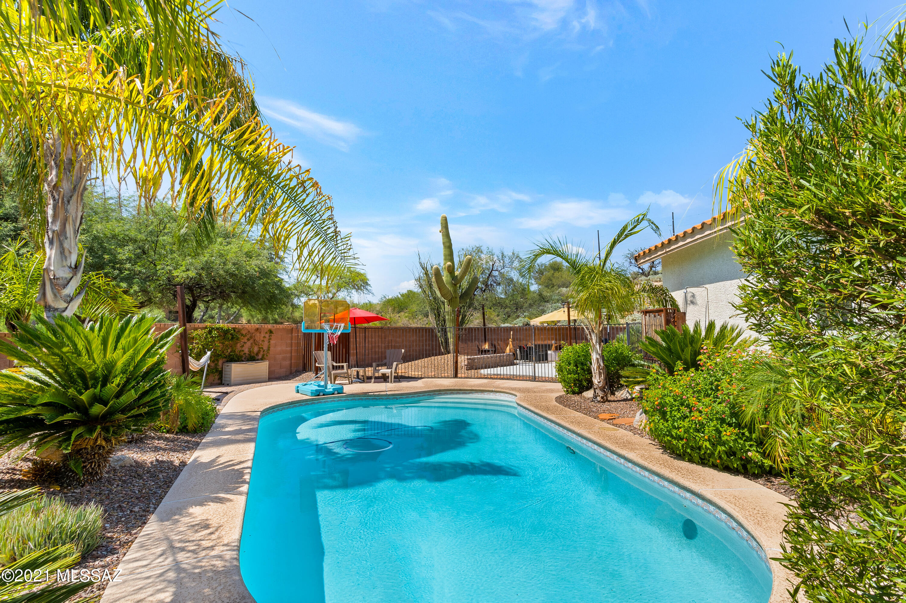 Extreme privacy and an impeccable home located in Oro Valley and within
Villages of La Canada gated community. Premium lot at the end of a cul-de-sac backing to a mountain reserve surrounded by a golf course and spectacular sunset views. Relax in your large pool enjoying the
resort style surroundings, lush landscaping, citrus trees and much more. Extended cover patio and storage shed-workshop off patio. Extra Room on the main level for guest/den/office. Large family room contains a dining area with plenty of natural light. The spacious upstairs master has an extra bonus room off master that is a great workout room or private retreat.  This is a truly fantastic home close to Basis School, shopping, bike and walking trails.