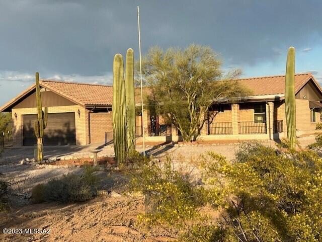 Beautiful home and guesthouse in the highly sought after Old West Ranchettes. This home has been fully updated in the last few years - new kitchen with granite countertops and new appliances, bathrooms with new tile and granite countertops and custom concrete flooring throughout. The guest house out back has new paint, bathroom and kitchen with quartz countertops and has a mini-split. Covered porches and patios for your entertaining pleasure, plenty of space to install a pool. Enjoy quiet mornings and evenings watching the sunrises and sunsets. This property is on a newly paved County road just south of the Picture Rocks Community Center, park, community pool and skate park. The elementary school is walking distance. Make an appointment to see it now, as it won't last long.
