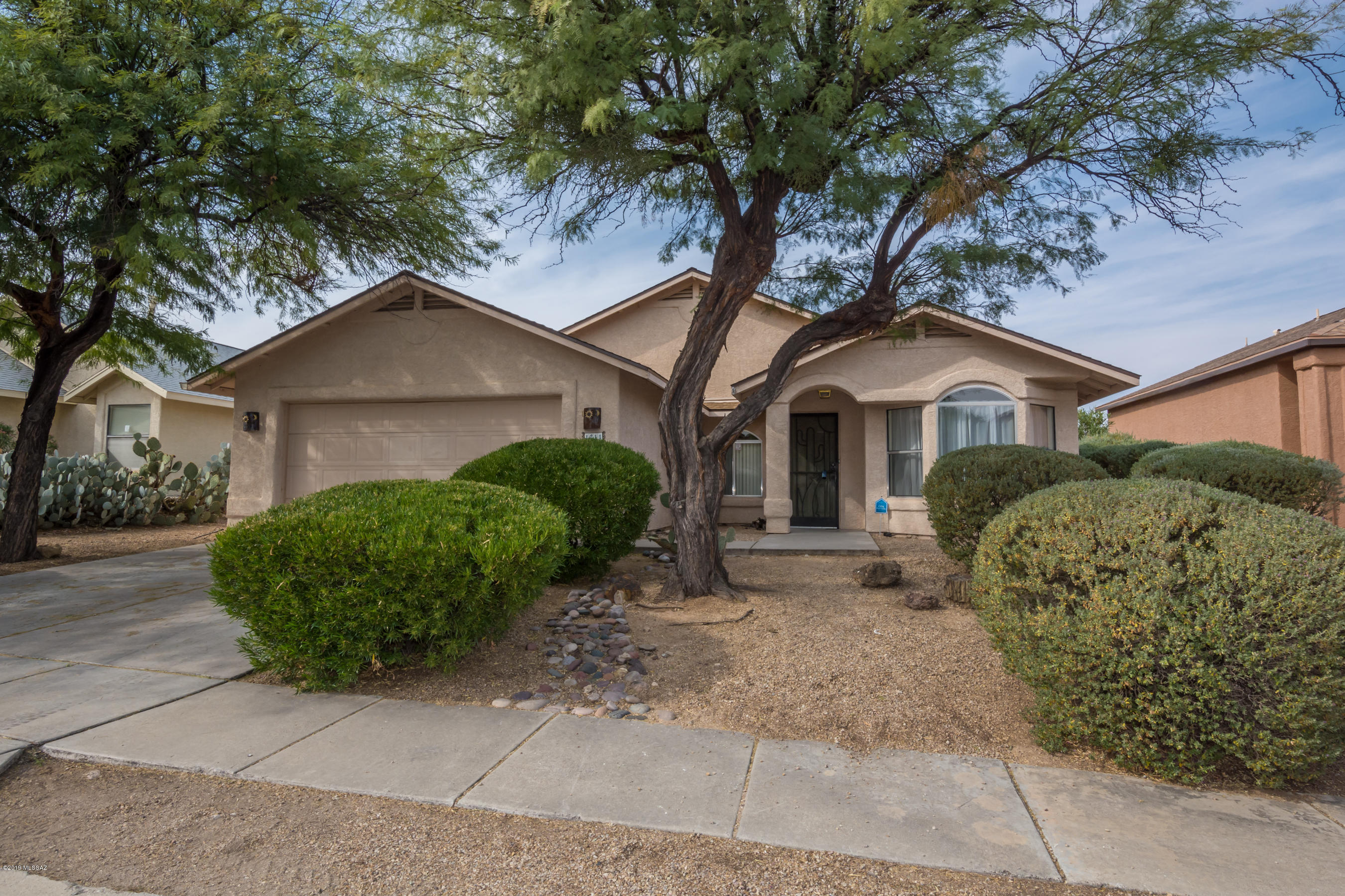 This home is light and airy and truly ready to move in. It has neutral tile and colors and a great floorplan. It even has sunset AND mountain views!  The yard is spacious, and it has mature landscaping and views.
AC unit was replaced in 2017 and a new roof in 2016. It also has a rain water harvesting tank too.  It has a huge back porch and great space inside and out.