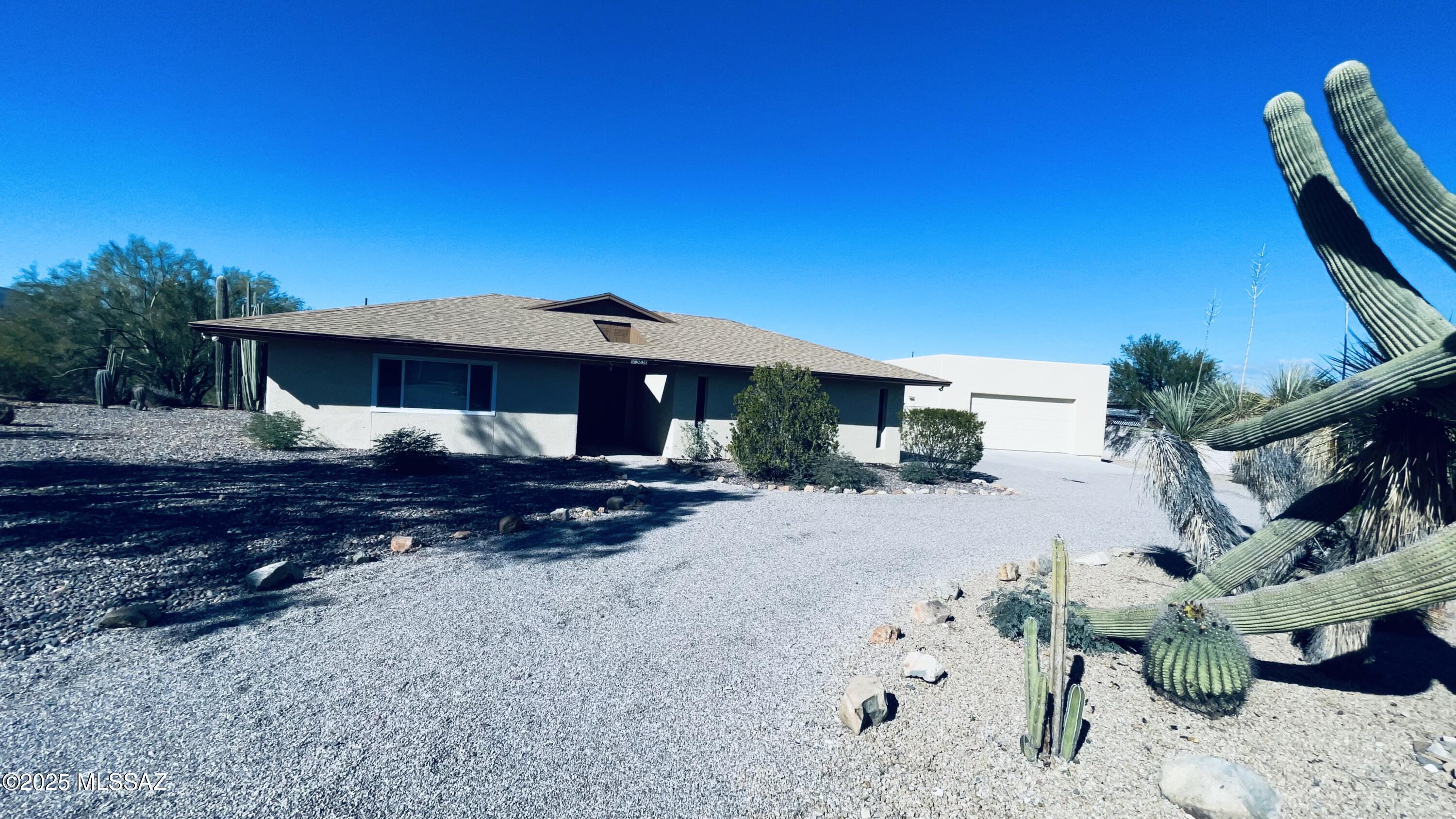 West Side Beauty on over an Acre - A rare find with space, views & extras.
Discover this private gem w/mature desert landscaping & open views. This 2405 sqft home features 3bed/2bath, offering a comfortable & functional layout ideal for everyday living & entertaining. 
Recent upgrades provide piece of mind, including a roof and exterior paint both less than 2 years old.
Enjoy the convenience of an attached 2 stall garage, plus a detached oversize garage complete w/ a car lift-perfect for hobbyists, collectors or anyone needing serious workspace.  Behind the detached garage, you'll find an additional oversize shed for even more storage.
This property offers room to spread out, room to create & room to enjoy life on your terms.  A truly unique opportunity. Relax in the enclosed patio or wander the property's peaceful ground, filled w/ established plants, cactus & a charming ramada area w/citrus & fruit trees - a quiet spot to unwind and enjoy the outdoors.