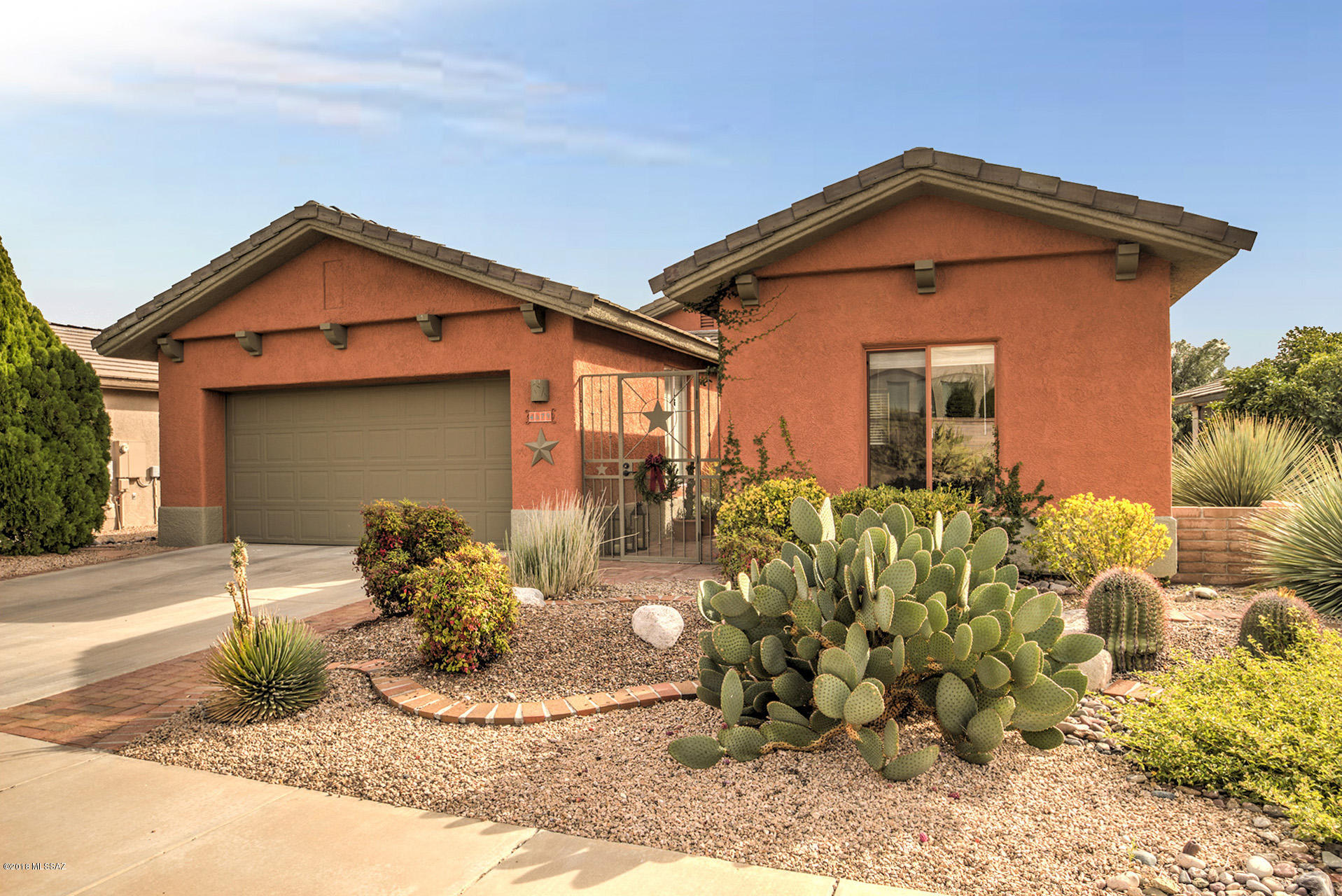 An attractive iron entrance gate and red brick walkway welcomes you into this beautiful home. Past the Standalone Casita, a lovely landscaped courtyard leads into the home, and Tile Flooring complements soft southwest color decor with stylish finishing touches. Tile counters and custom cherry cabinets/light fixtures can be found in the updated bathrooms and kitchen, which features SS appliances, a large pantry closet and lots of counter space. The great room with vaulted ceiling is spacious and adjoins a large dining area, and a Sliding Glass Door leads to the well landscaped back patio, which has nice mountain views. Custom, built-in cabinetry can be found in the Master BR, Den and Great Room, and the split floor plan plus the casita makes this home a welcoming oasis for family or guests.