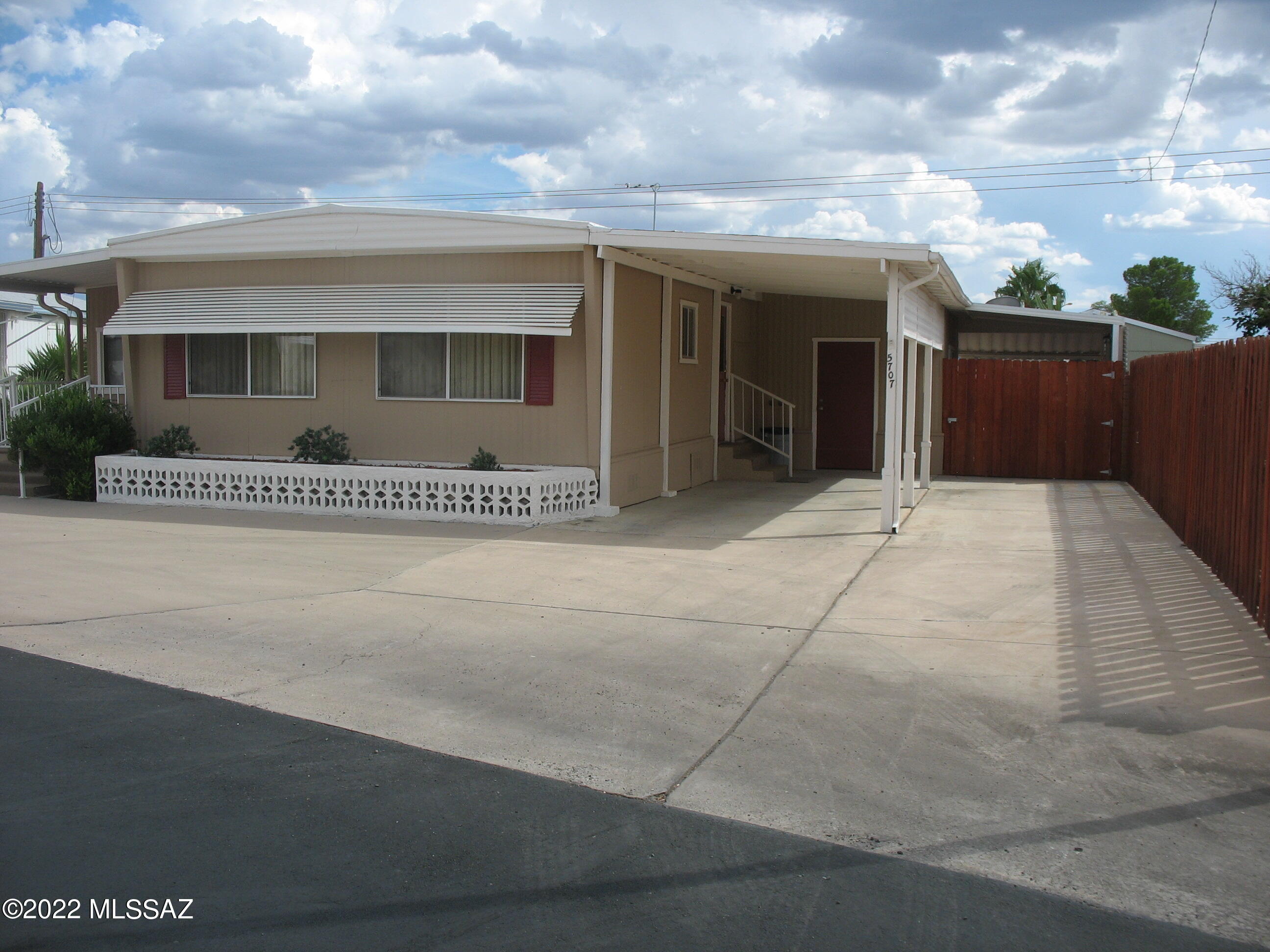 Very well cared for north facing home including gated and covered area for a golf cart or small car. Large shed/workshop includes laundry. Gas Pak central air conditioning. There is a heated and cooled AZ room off the living room. There is also an added room off the master bedroom with French doors that would make a nice office. The HOA fee includes unlimited golf, tennis, pickle ball, shuffleboard, pools, spa, exercise room ,trash collection, and much more. You own the land!