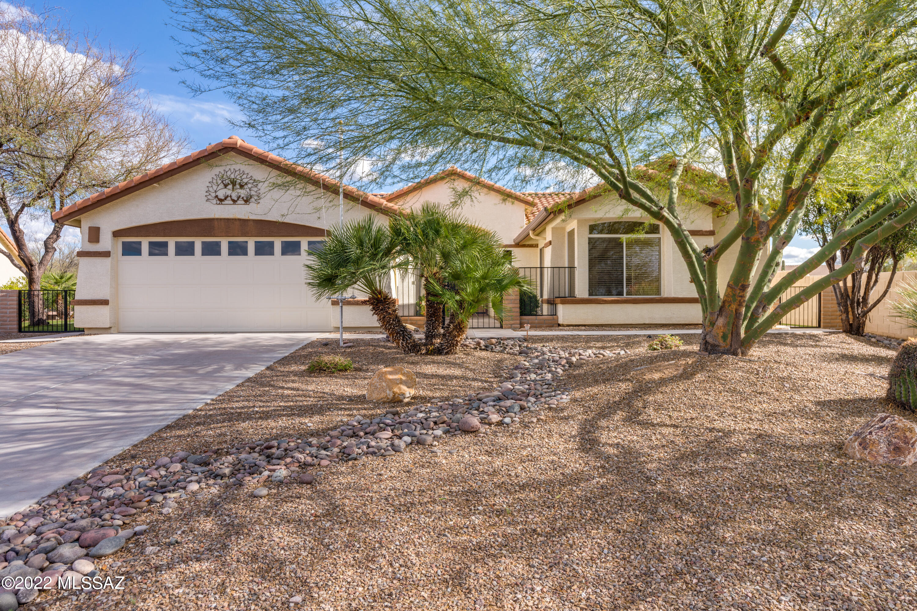 OWNED SOLAR W/Tesla Back-up Batteries for power outages.  Front golf course views, a wash view in the back -- enjoy wildlife & birds from your very own AZ room.  Add a pool to the private side yard w/raised beds, mature vegetation, Astro-turf & fruit trees.   This modestly priced 2 bedroom 2 bath home has  plenty of square footage (2290) & leaves room in the budget for your own special touches.   Stainless steel appliances, gas drop-in range, convection wall oven R.O in kitchen faucet, refrigerator & icemaker installed in 2018. Enjoy golf course views from your kitchen nook or entertain in the open concept dining room that opens to the great room. Spacious Primary en suite with  updated new shower tray.  Walk-in tub in guest bath.  New water softener 2018.  NEW ROOF TO BE COMPLETED 4/24.