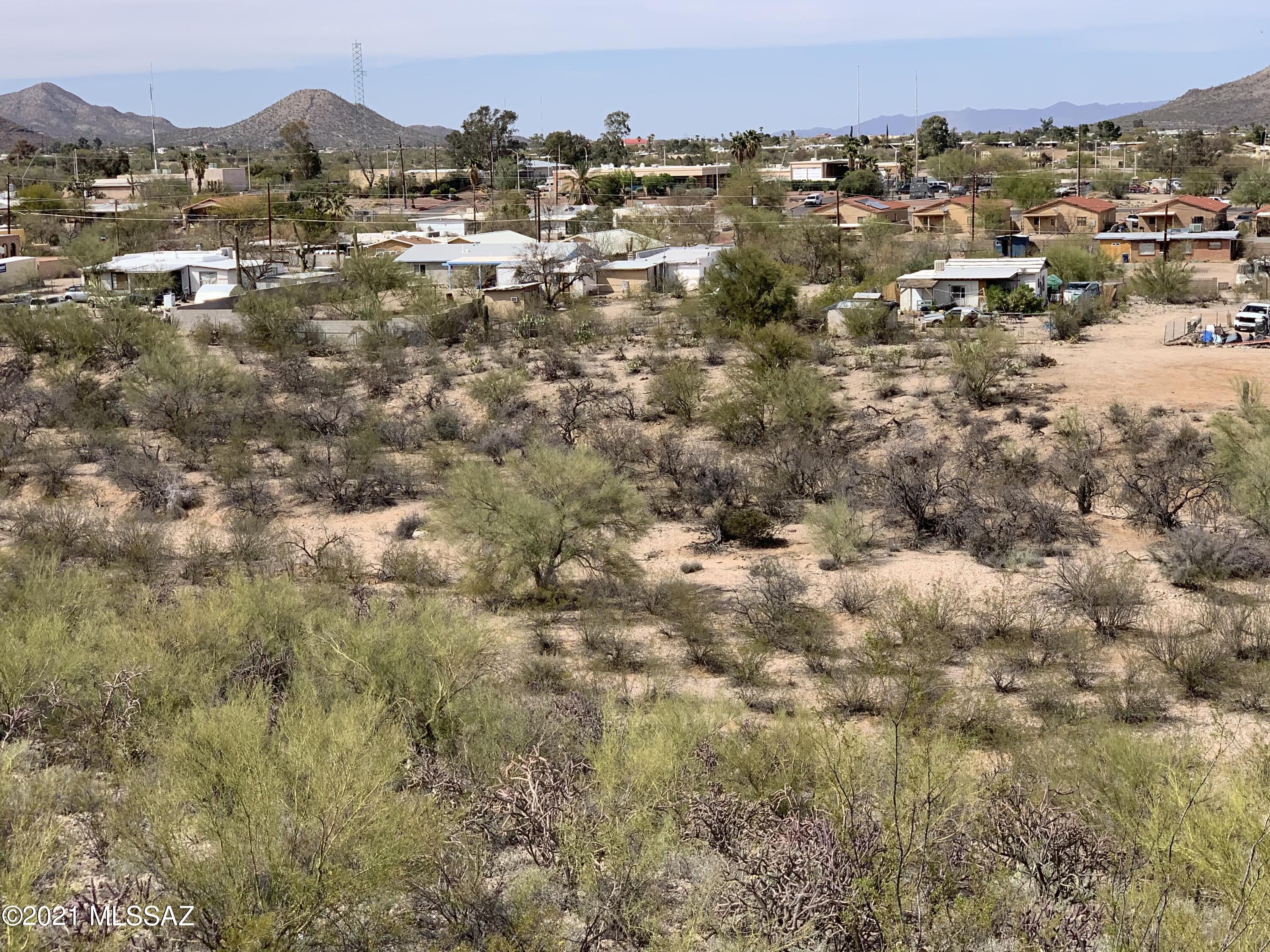 8 lots 50x180ft each. Total acreage 1.65+-. This group of lots is being sold as a bulk because it's best suited for 1 residence. Probasco Addition is a very old City of Tucson subdivision where several platted streets and lots were never developed. This property has a 20ft utility alley along north boundary with a sewer pipe installed. Brown Ave is 60 ft wide along south boundary but is not graded or developed. That's why you need to walk in to tour the lots or view them from Mollohan Dr. Roughly 25% of the land is FEMA Zone X, the rest is FEMA Zone AO. It's an interesting & challenging parcel. Interesting because it's super close to city amenities and challenging because it lacks infrastructyure. Think creatively and you could have a unique homesite within city limits!
