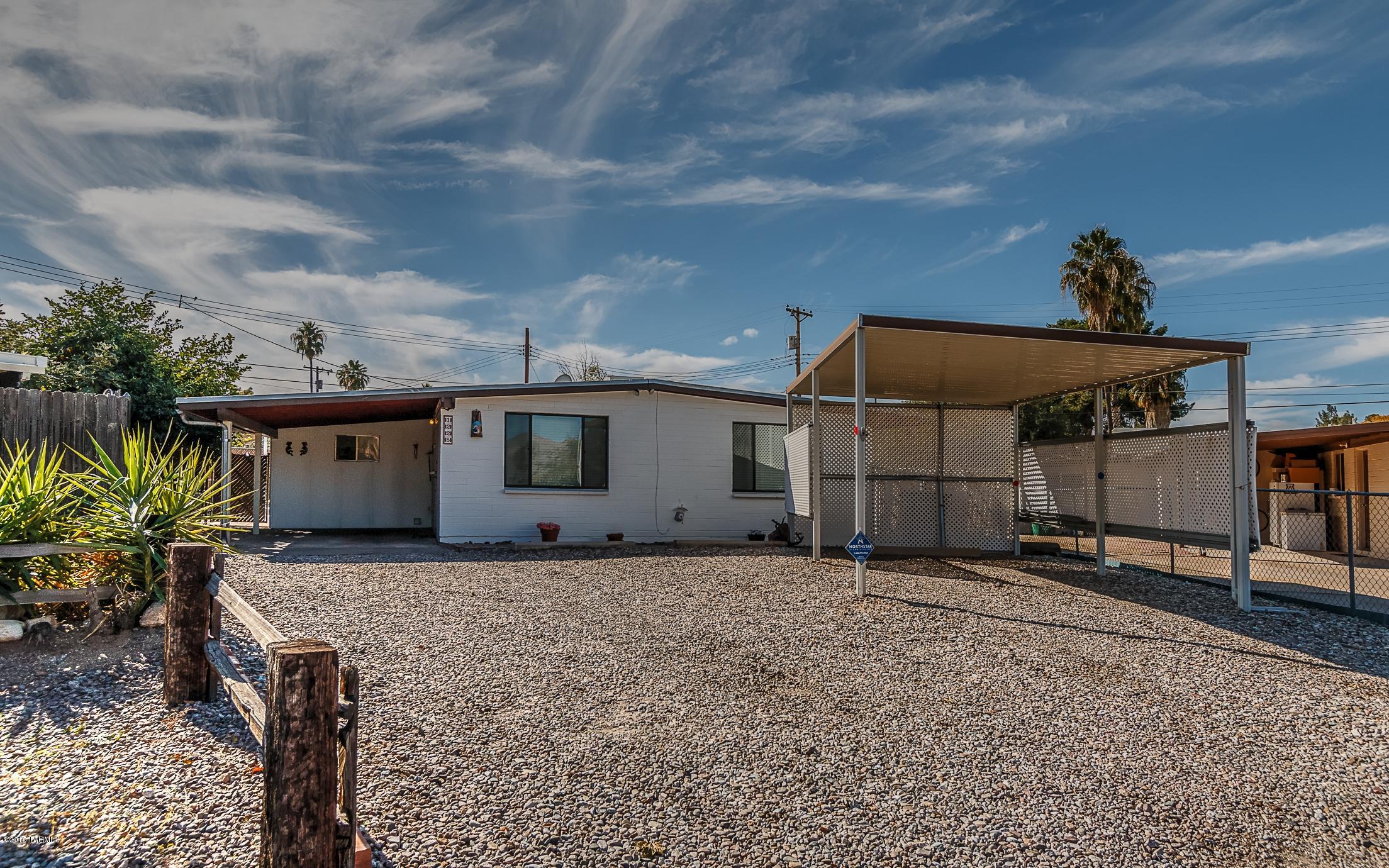 Hard to find original owner home that is immaculate. Spacious 3 bedroom 2 bath home with den. Large picture window to enjoy the Catalina Mountain views. Easy care ceramic tile throughout, dual pane windows, ceiling fans in all rooms, security alarm. Large yard with 2 car carport, huge steel enforced shed/workshop with electric and double gate entry to back that is big enough to park an RV. New HVAC unit in 2010 and priced to sell with all appliances included along with washer/dryer!