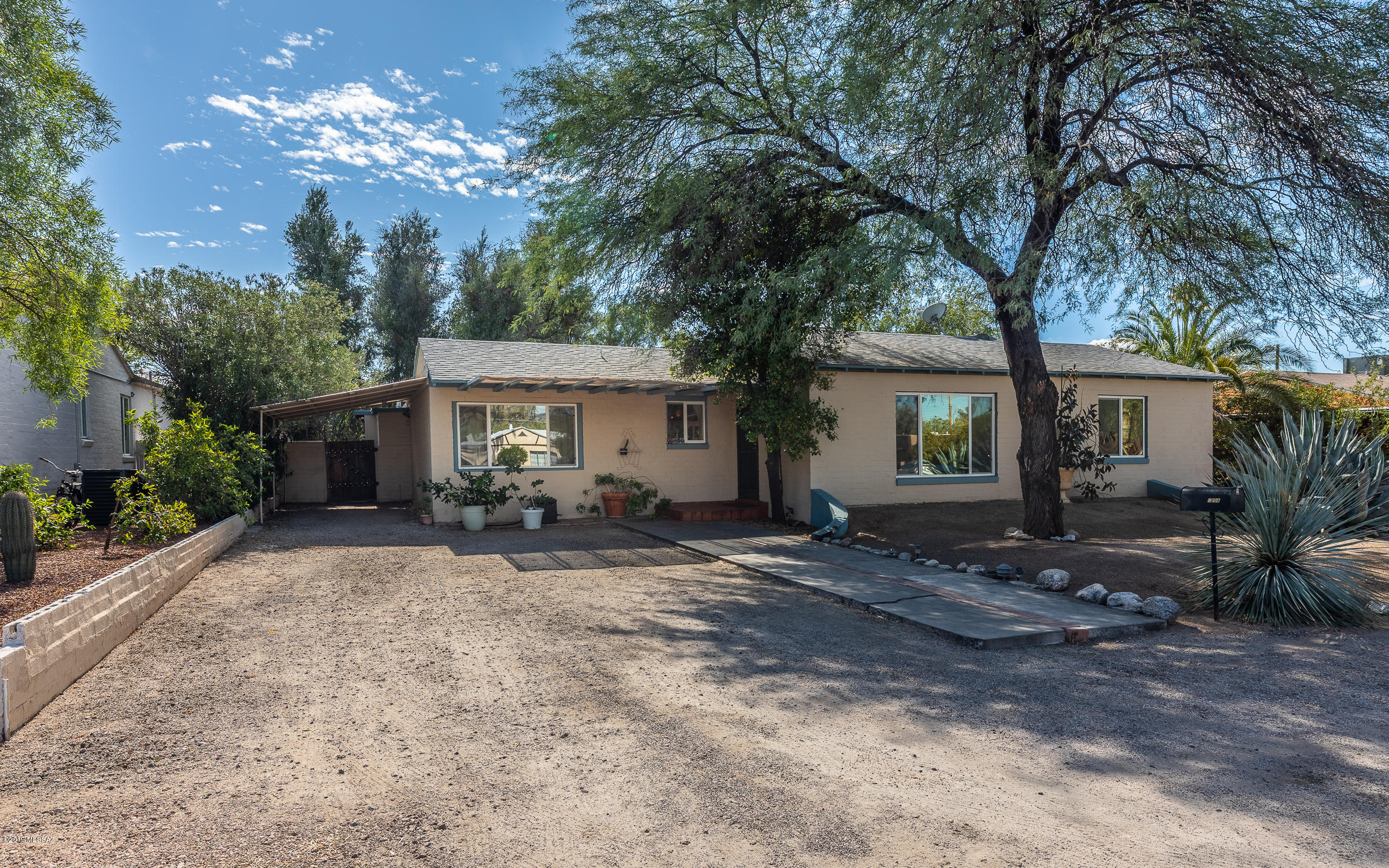 YOU WON'T WANT TO MISS! Walk right in and feel the charm of this Peter Howell abode. Lots of windows overlook the backyard, with grass and mature landscaping for tons of privacy. Like your own private oasis. Separately fenced for dogs or perhaps a future pool. Chicken coop potential, garden bed, clothesline and 2 storage sheds for all your toys, hobbies and holiday decor. 4 bedroom, 2 bathroom floor plan. Split master with tons of built-ins and closet space. Granite tile kitchen counters, slide-in gas range and stove. Breakfast bar. Wood beamed ceilings. New carpets in bedrooms. Closets reconfigured with interior lighting and sliding doors for more space. Beautifully stained concrete floors. Single-carport with outdoor laundry. Buyer to verify all facts + figures, including those in MLS.