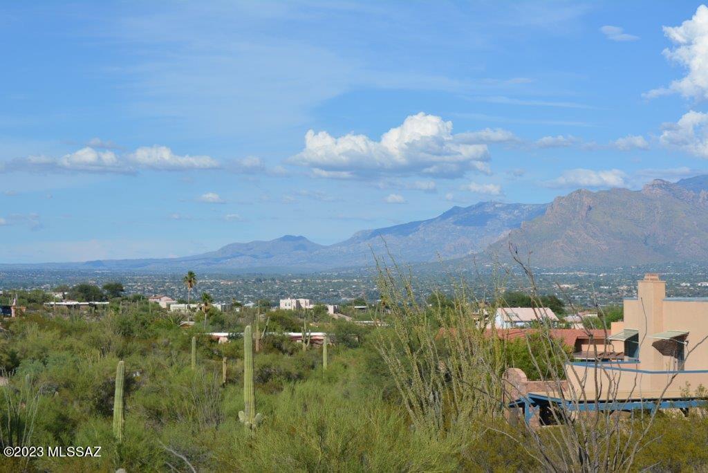 Rare Rancho Del Cerro one acre view lot in Tucson Mountain Foothills on newly repaved subdivision street. Rolling building site with numerous Saguaros. Barrel Cactus, Cholla and desert vegetation. View Sun rise and Moon rise over the Catalina mountains and valley. Walking distance to Sweetwater Preserve hiking/bicycling/equestrian trails. Easy access, via new I-10 overpass to downtown U of A, Tucson airport and Raltheon. Perfect lot for split-level home with minimal site excavation. Architectural plans available. Underground utilities to lot front. NO HOA