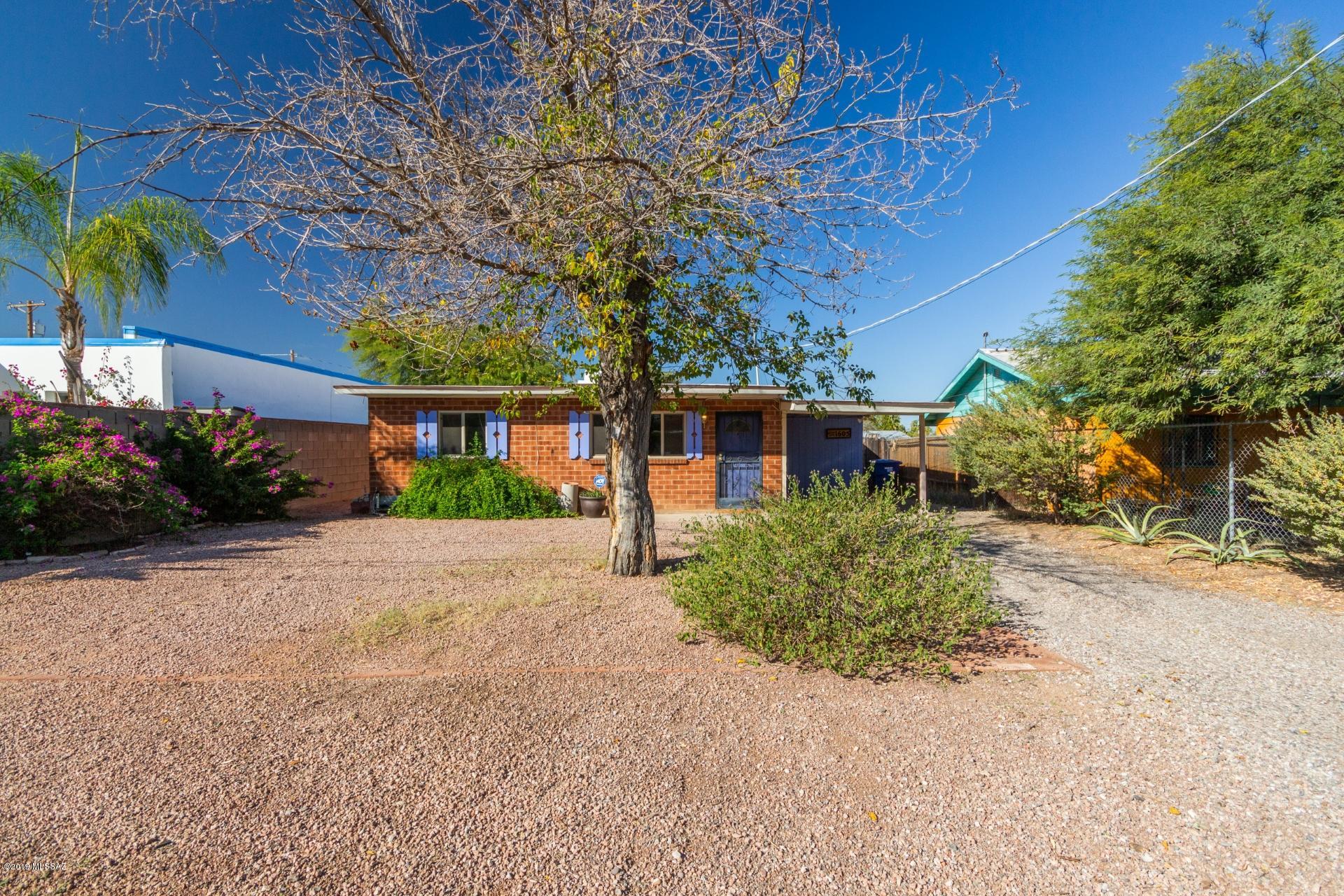 Absolutely charming, red brick 2 bedroom plus bonus rm home in the heart of Tucson. Excellent central location, close to Trader Joe´s,coffee shops & lots of other popular shopping & restaurants. Huge front & back yards with side gates & plenty of room to start a garden or pool or build a studio/workshop. Inviting interior is bright and open. No carpets for easy maintenance. New windows!! Fresh paint inside and out. Spacious living area leads into the kitchen with lots of cabinet & counter space & french doors. Plus a bonus room off the kitchen. Sun soaked Arizona room, a perfect spot to relax and enjoy a morning cup of coffee. Totally private backyard. This gem is offered at an incredible value and will sell fast. Act fast and schedule your showing now.