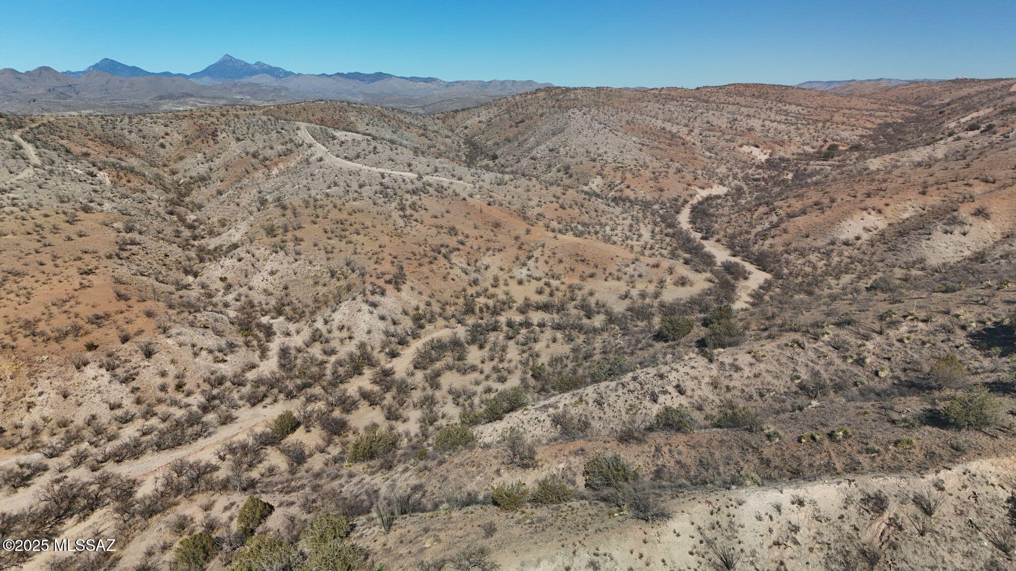 Above the Santa Cruz River Valley, Southeast Rio Rico, among rolling hills and plateaus, find privacy at this high country 42.62 acre vacant lot in Sonoita Creek Ranch Estates, gated-community. Many options for development and build your custom home. where your can take in panoramic views and fabulous sunrise/sunsets from your porch. See parcel maps and documents attached.
