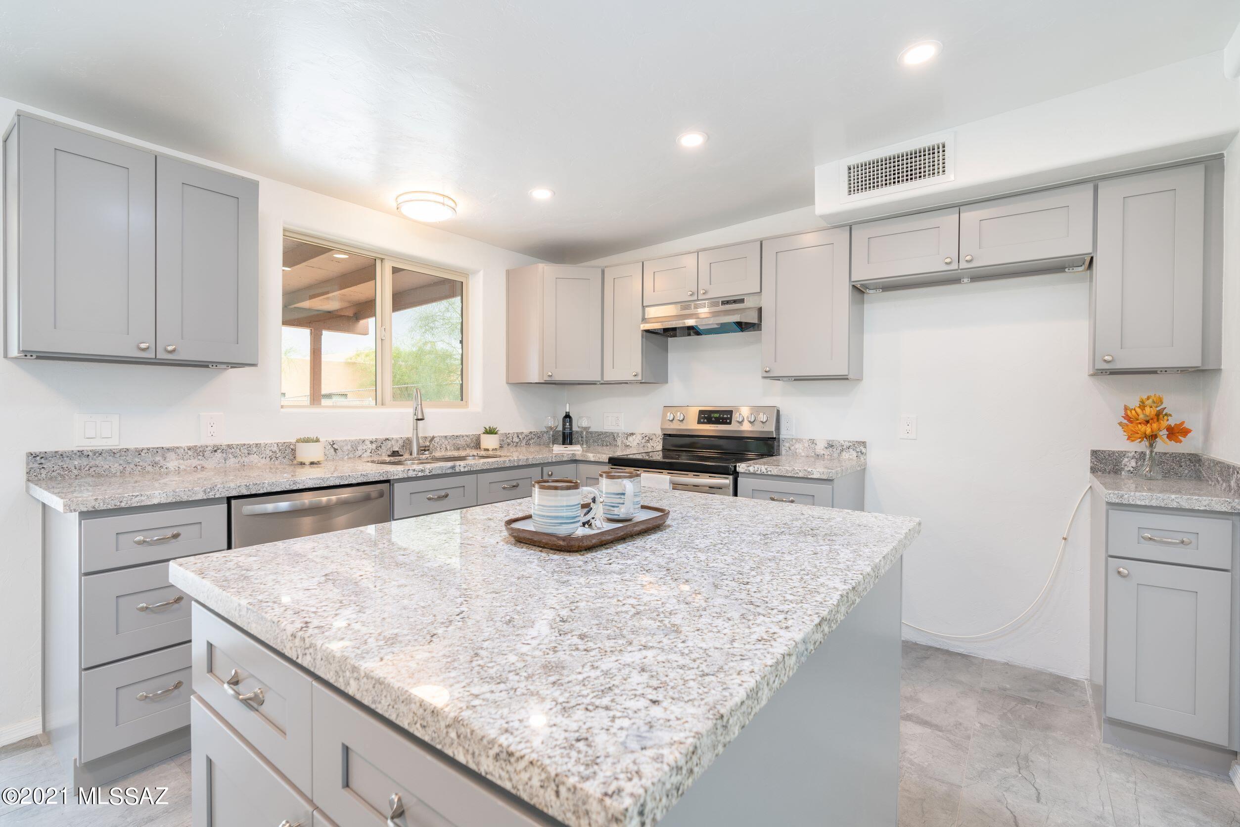 Completely remodeled, just for you, this 3-bedroom 2-bathroom home is move-in ready and features an open concept kitchen / great room.  Lots of lighting throughout the entire home make it inviting for guests and family.  There is a large master bathroom with beautiful walk-in shower and the guest bathroom features double sinks with large vanity.  Modern ceiling fans and a new HVAC unit will keep the temperature, right where you want it in the summer or winter.  Upgrades include new windows and sliding glass doors, tile flooring throughout the home, and a spacious detached laundry / storage room.  Conveniently close to shopping, recreation, dining, and Davis-Monthan AFB, this great opportunity is going to be gone in a flash!