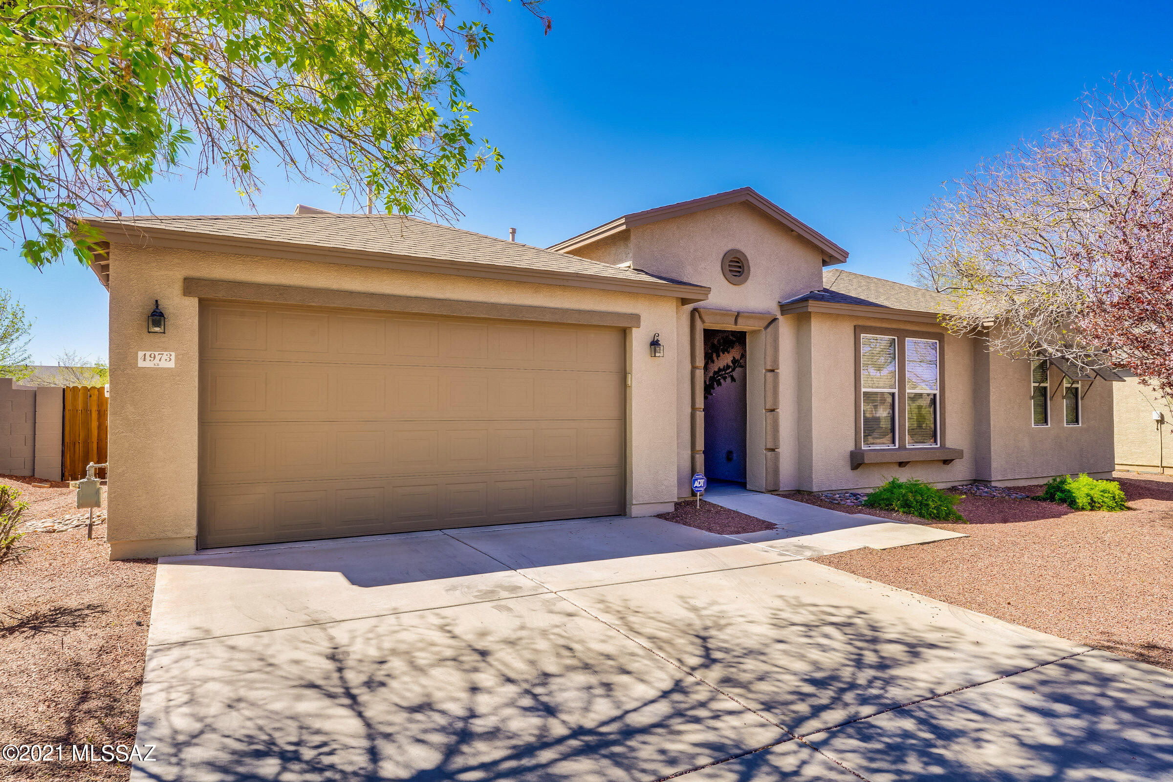 This beautiful 4 bedroom home with sparkling pool is ready for it's new loving owners. The back patio cover extends the length of the home to give you plenty of shade for enjoying your outside space. Paver patio extends out to the inviting pool. Tall block wall. The home backs up to a small wash. Upgraded kitchen with island, gorgeous kitchen cabinets, corian countertops. Cultured marble in bathrooms. Two car garage with a water softener. Simple, yet elegant landscaping that includes grape vines. North/South exposure. Garage sheetrocked and painted. Exterior painted in 2019. This home has been meticulously maintained.
