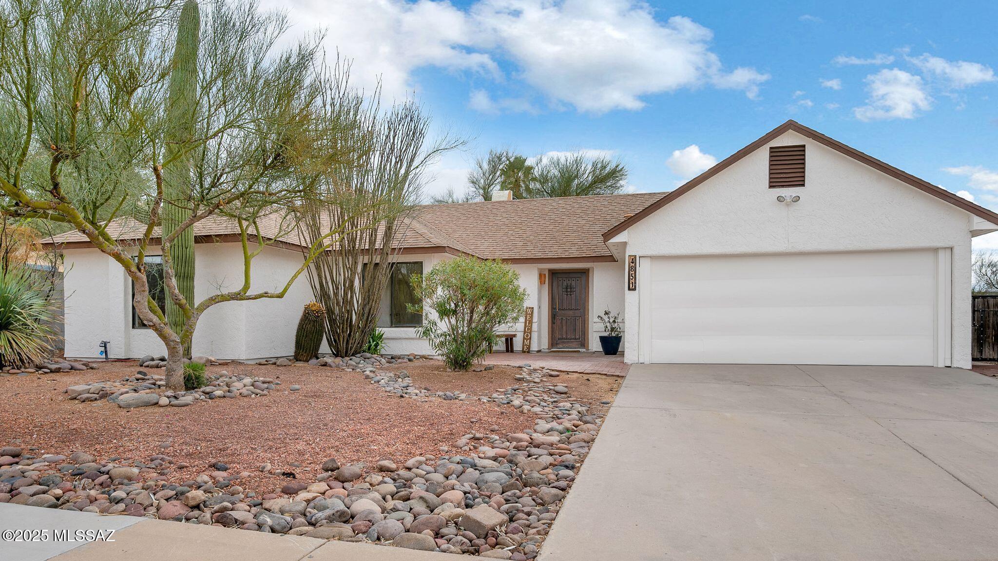 Find your perfect home in the sought-after Northwest Tucson community. This charming 4-bedroom, 2-bath home with a split floor plan blends modern luxury with desert living. Inside, a bright, open layout flows effortlessly between spaces. Expansive windows and vaulted ceilings fill the home with natural light, offering views of your private backyard adn entertainer's paradise.

The chef-inspired kitchen features sleek new countertops, stainless steel appliances, and ample cabinetry, perfect for meal prep or hosting. The spacious primary suite is a serene retreat with a spa-like en-suite and walk-in closet.

Step through French doors to your desert sanctuary with citrus trees, an extra-large covered patio, and low-maintenance landscaping, all backing a peaceful common area.  no HOA!