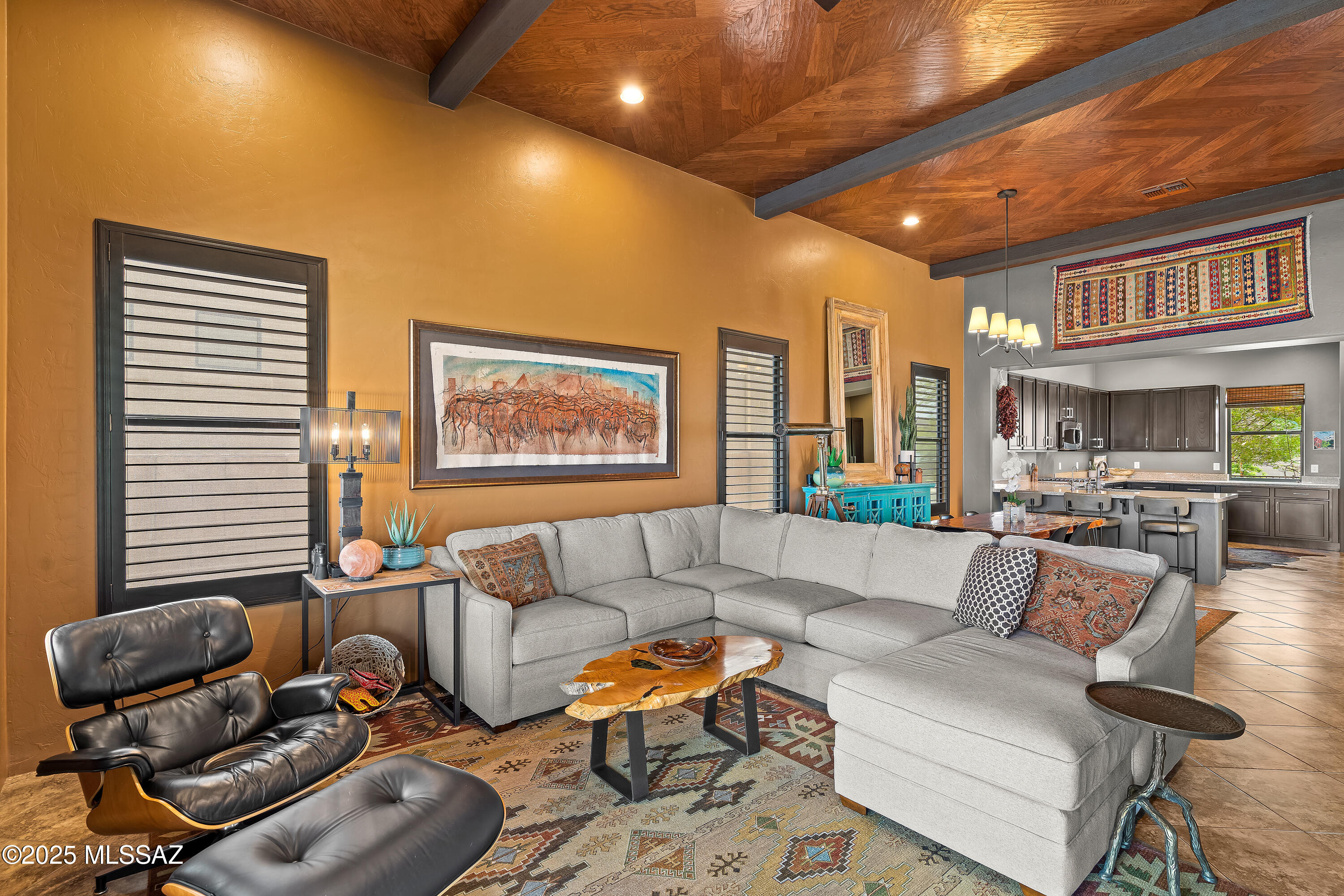 Designer-owned - for the Buyer who appreciates attention to detail - this stunning home offers two private courtyards, authentic Mexican tile, custom metal gates, and breathtaking Catalina views. Inside: chevron wood ceilings, a stone fireplace wall with mounted TV, wood shutters, and high-end finishes throughout. Chef's kitchen with gas stove, soft-close cabinetry, and filtered water system. Luxurious bathrooms with custom tile, glass showers, and California Closets in multiple rooms. Newly landscaped and updated front and back yards with new drip systems, extended patio pavers, lighting, invisible and snake fencing. Smart thermostat, tankless water heater, Kinetico system, epoxy garage floor, and more. A rare blend of design, function, and desert beauty.
