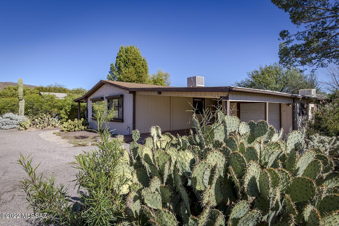 Just reduced 21k!   Spacious fixup on quiet cul-de-sac, in Tucson Estates 2.  (not 55+!) Tucked back in the gated neighborhood, this home has been loved as a full-time residence since 2005 by same owners.  One might also choose this home as a winter residence, and there are no age restrictions!  The original home is 1311 sq ft, spacious 2 bedroom, 2 full bath, and greatroom living area, dining, and kitchen.  The addition in '93 is a 257 sf bonus room, useful as an office, art studio or guest space. The home is affixed, has gorgeous views, AC, and private outdoor space. With a little updating, this home will be stunning.  If peace, quiet, the Desert Museum, Cat Mountain, and miles of pristine desert are important to you...don't hesitate!  STRICTLY AS-IS, seller will perform no repairs.