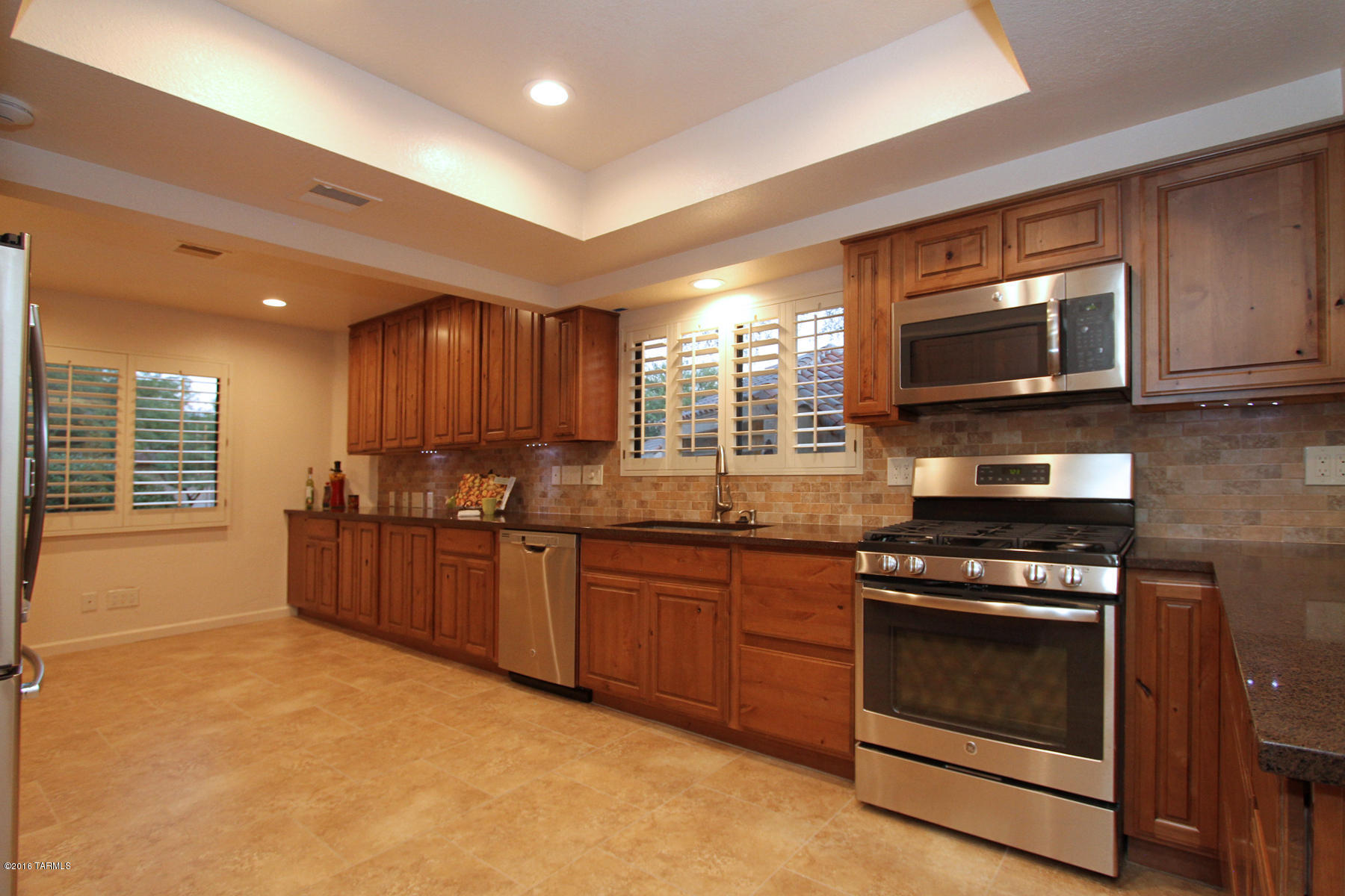 This  Golf Villa is 1817 sq.ft.,  has 2 Bedrooms, 2 full baths, a Den and has been COMPLETELY REMODELED: MOVE IN READY! Come see for yourself!  We've added: New Neutral 20'' tile throughout, New easy close Alder Cabinets and Silestone Counters in both Kitchen and Baths. New Gas line added for Gas Cooking.   New GE Washer and Dryer plus utility tub in Laundry room; both Bathrooms have been completely remodeled with a Gorgeous Tile and Glass Walk-In-Shower in Master Bath. Freshly painted neutral, with all new lighting fixtures (also lots of ambiance lighting), new door hardware and all new plumbing fixutres. Irrigation has been added to the back patio which faces the open, green driving range. Don't miss!
