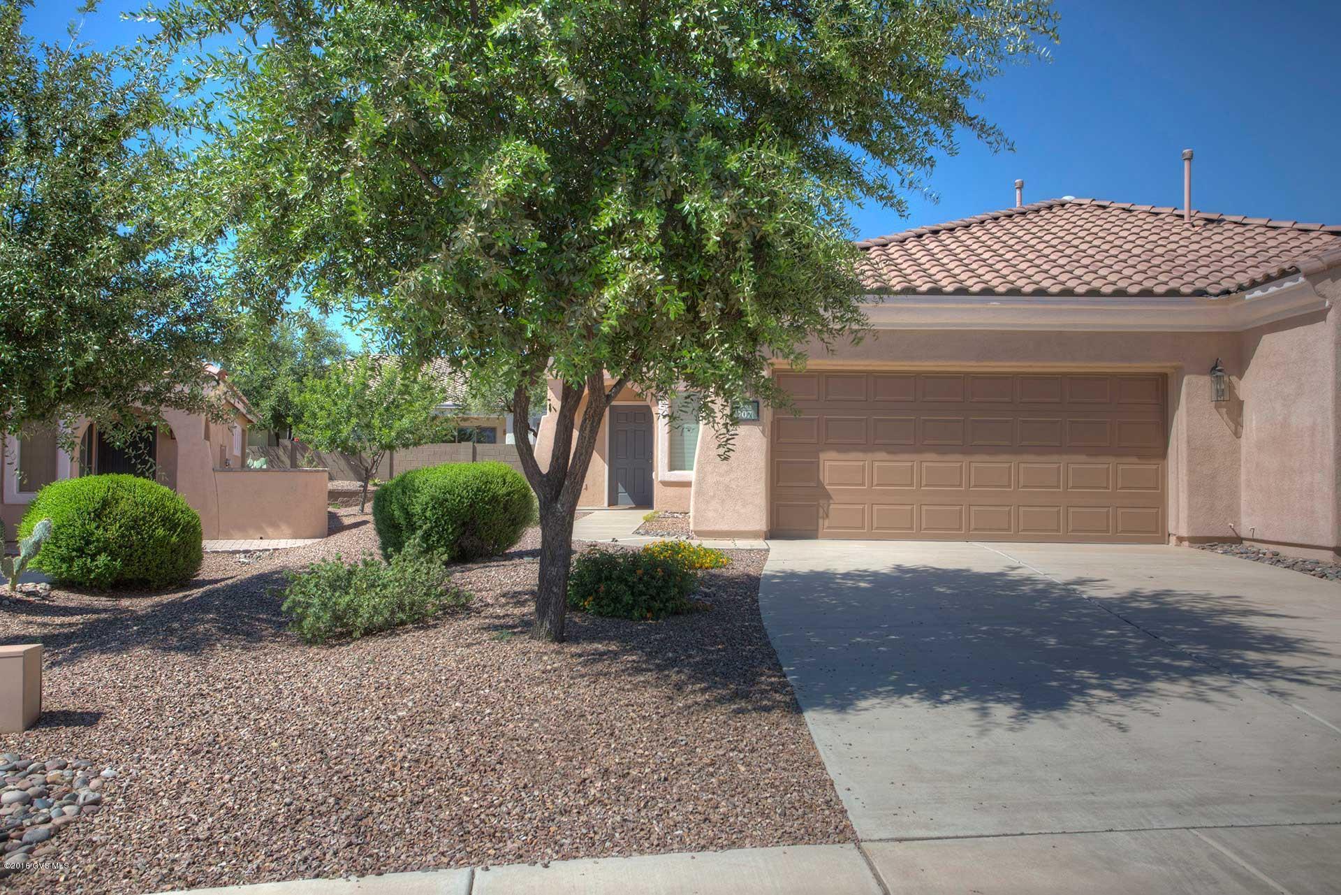 REDUCED! Fantastic 2 BR townhome in 55+ Sonora, a Del Webb community in Rancho Sahuarita. Beautifully maintained split bedroom plan offers great room for living and dining with gorgeous 18 tile floors. Kitchen has solid surface Corian counter, black appliances, breakfast bar, honey oak cabinets, lazy susan, pantry closet. Master bedroom includes walk-in closet, adjoining bath with executive height cabinets, dual sink vanity. Plush neutral carpet in both bedrooms. Adjacent common area desert has walking paths and picnic area. Ideal winter home or carefree year-round living, HOA covers landscaping, irrigation, roof, ext. paint, ext. pest control. Enjoy private amenities exclusively for Sonora residents, incl. clubhouse, pool, spa and more, and family-friendly facilities of Rancho Sahuarita.