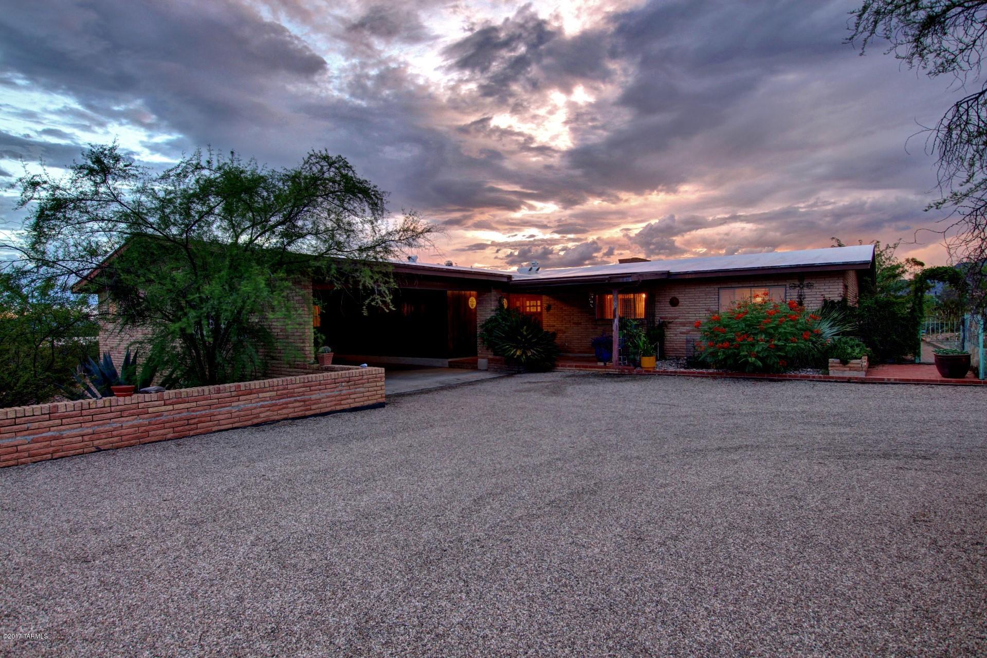 Fabulous Views! This Charming Ranch style home is resting on 1.48 acres on a cul de sac lot and Located in the desired Catalina Foothills. Open and bright kitchen with unique classic pull out stove, breakfast bar and ample cabinet/counter space. FRESHLY PAINTED. Large living room with fireplace, formal dining area, extra den/office and Saltillo tile throughout. Spacious master suite with access to the patio. Huge Wrap-around Covered Patio, great for entertaining. New AC and Hot Water Heater (2015) Roof re-coated (2016) All new Drip System. Gorgeous Sunset and Mountain Views! Tons of parking and storage space. Quiet and private. A must See!
