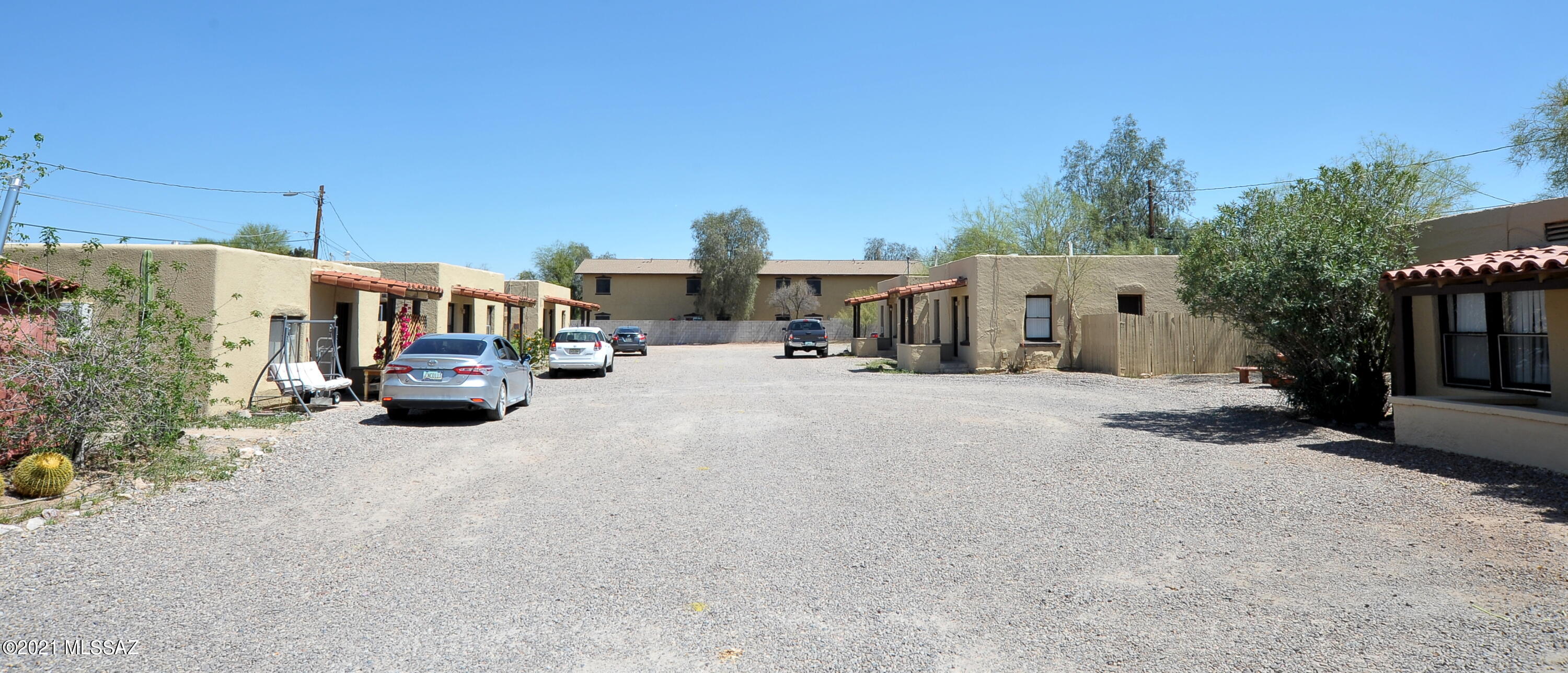 Great location near University of Arizona, I-10, Pima Community College, shopping, restaurants, golf, biking & bus routes. The property consists of one 2 BR house w a den, another two BR house and seven 1 BR casitas for a total of 9 separate houses on almost an acre of land! Additional room for growth with vacant land space. Charming units have covered tiled front porches, most have hardwood flooring, and there is an abundance of parking spaces. Improvements to the units include privately fenced backyards, stucco patched and painted, and owner has started to add A/C Mini splits in the units, 3 have recently been installed. There is a common area with seating for a friendly environment on the property. Tucson rents are escalating at a record pace so there is room to raise the rents.