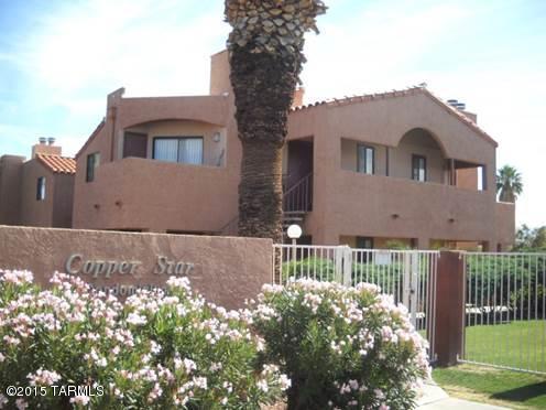 PERFECT LOCATION & GREAT VIEWS! 03 COVERED SPACES!! LARGEST CONDO IN SOUGHT-AFTER GATED COPPER STAR SUBDIVISION IS NOW AVAILABLE FOR SALE W/VERY BIG ENCLOSED WRAP-AROUND YARD - THE ONLY 3BR IN SUBDIVISION. THIS AMAZING UNIT HAS BEEN FRESHLY PAINTED, HAS TILE FLOORS THROUGHOUT & COMES W/ STAINLESS STEEL APPLIANCES & WINDOW TREATMENT. THIRD BR IS HUGE & CAN BE USED AS MA BR, DEN/OFFICE OR FAMILY RM & FEATURES LARGE COVERED PORCH.  02 AC UNITS & 03 COVERED PARKING SPOTS IN FRONT OF UNIT!! MOVE-IN READY & SHORT DISTANCE TO ALL AMENITIES, RESTAURANTS, SHOPPING & PUBLIC TRANSPORTATION. BIKE, WALK OR JOG TO UA & UMC! THIS SUBDIVISION INCLUDES A POOL, SPA, EXERCISE ROOM, BASKETBALL COURT & CLUBHOUSE W/ LAUNDRY FACILITIES. THE HOA COVERS WATER, SEWER & WIFI AS WELL. SPECTACULAR VALUE AND LOCATION!